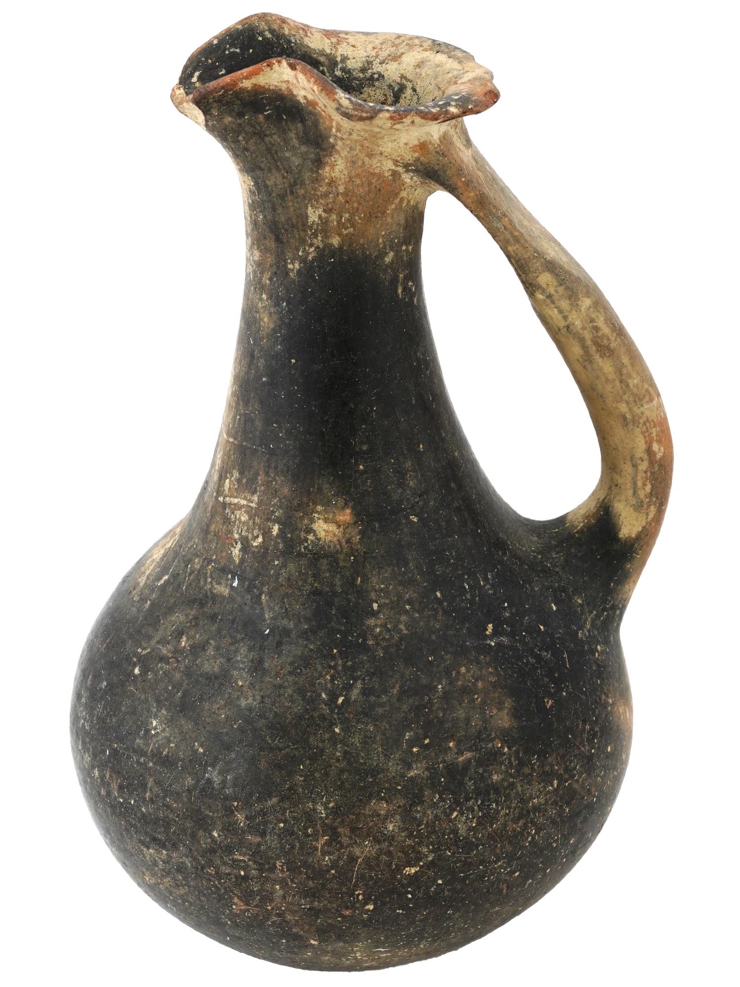 ANCIENT GREEK TERRACOTTA POTTERY OINOCHOE JUG: An ancient Greek black terracotta pottery oinochoe, a vessel for pouring wine. The jug is adorned with a trefoil lip, a long, gently curving neck, and a wide shoulder that tapers to a rounded body sta