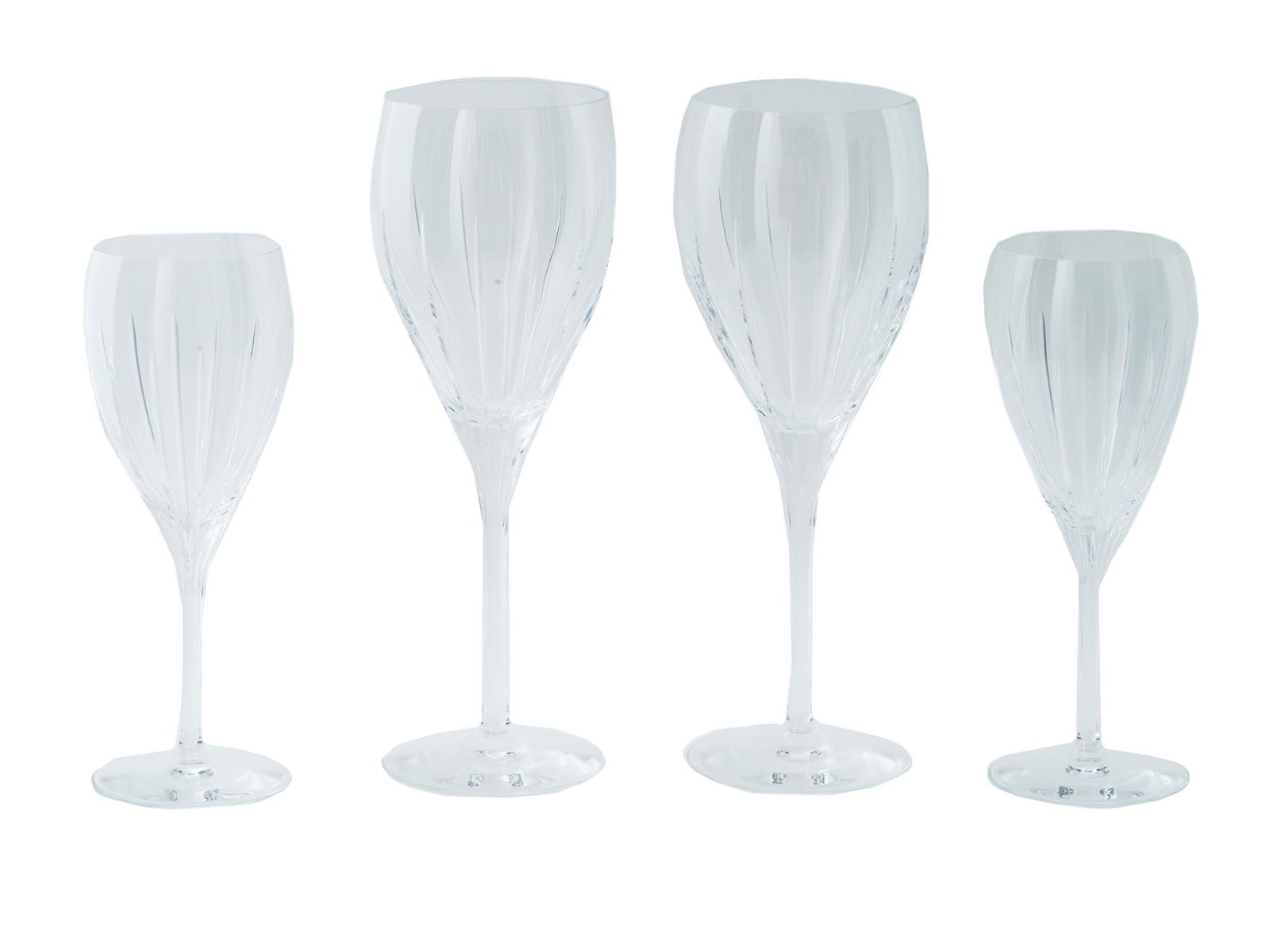 LOT OF FOUR CHRISTOFLE IRIANA WINE GLASSES: A lot of four Christofle crystal wine glasses in the Iriana pattern. Designed with a simple silhouette embodies timeless sophistication. Each glass has an etched signature to the bottom. Collectible G