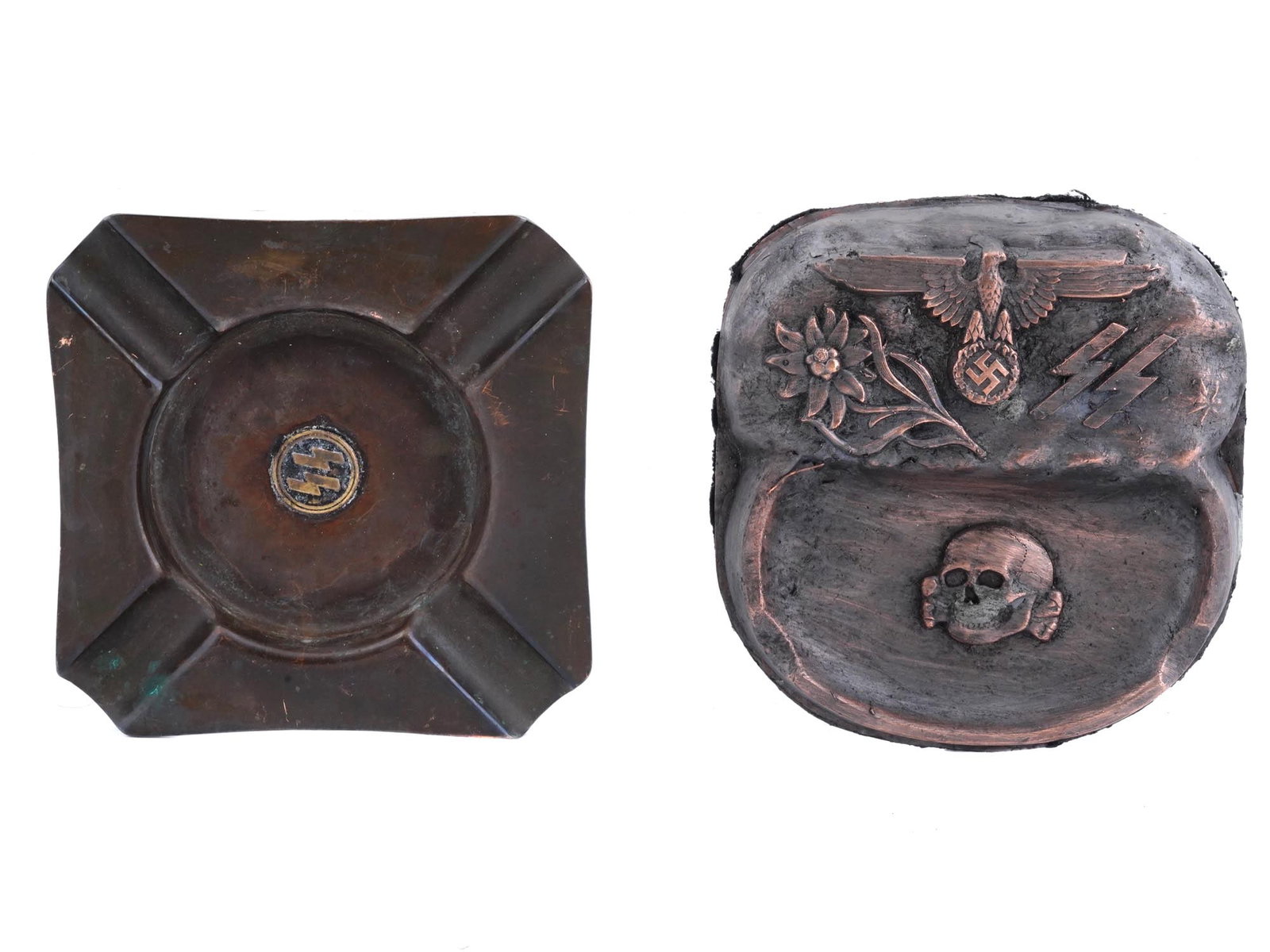 WWII NAZI GERMAN THIRD REICH MODEL ASHTRAYS: A lot of two WWII Nazi German Third Reich model ashtrays. The lot includes a square ashtray featuring an SS runes and four cigarette grooves, and a Waffen SS Totenkopf Mountain Troops ashtray. The sec