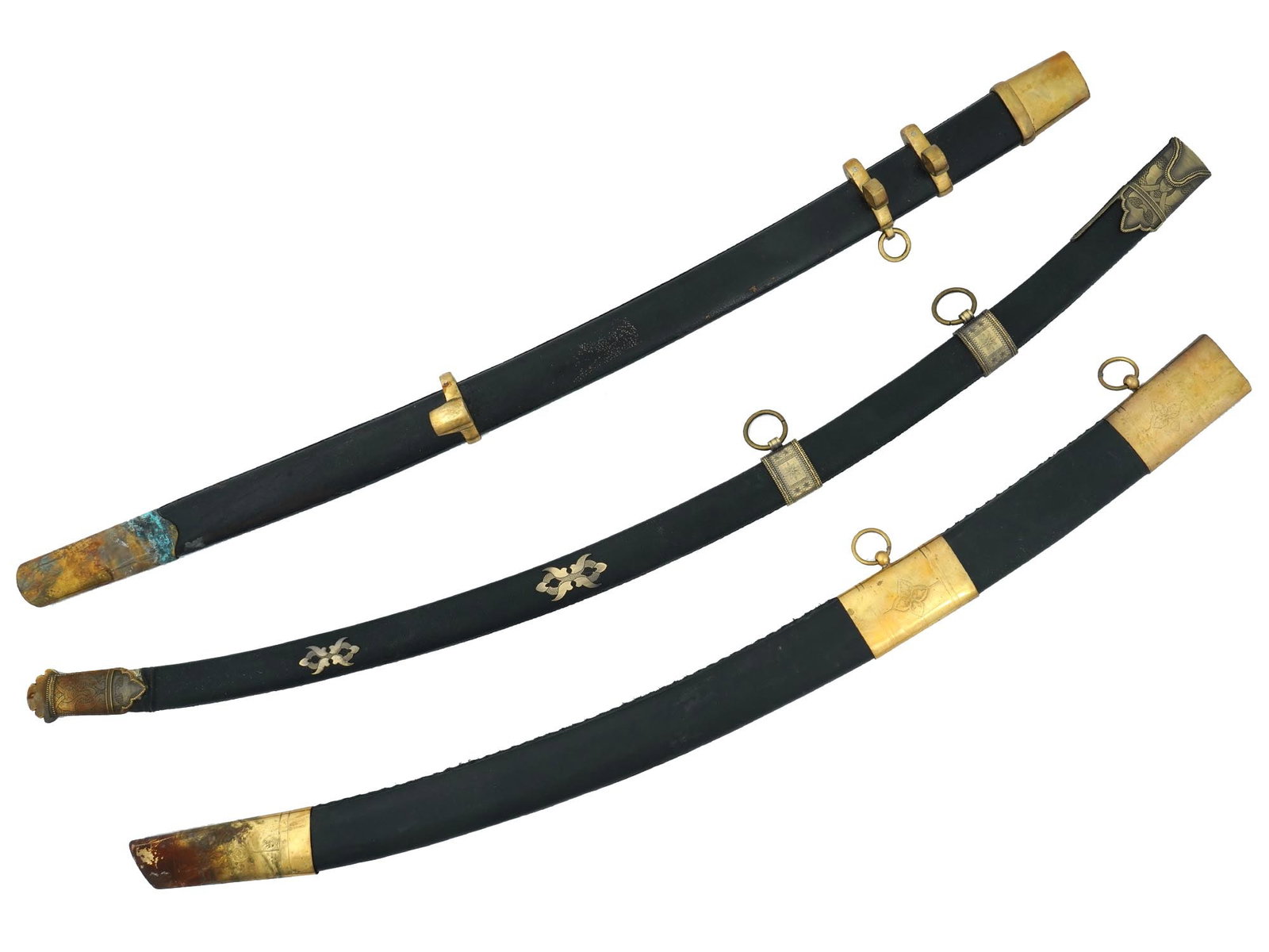 LOT OF TURKISH AND COSSACK SCABBARDS FOR SHASHKA: A collection of three Turkish and Cossack black leather scabbards decorated with brass mounts. The scabbards are adorned with etched floral, foliage, and scrollwork ornaments. The scabbards are decora