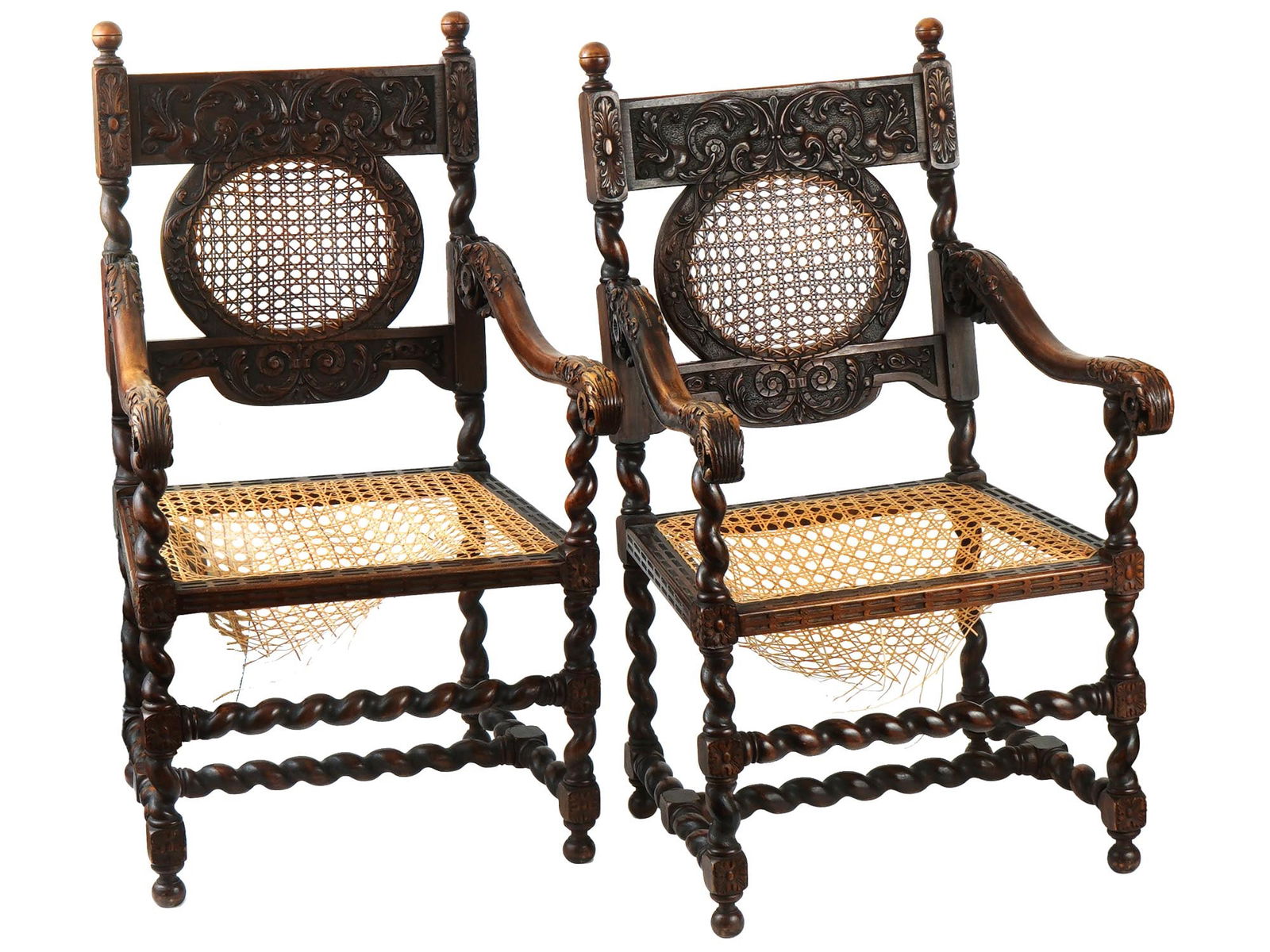 18TH CEN CONTINENTAL BARLEY TWIST CARVED ARM CHAIRS: An antique Continental hand carved wooden arm chairs. the armchairs feature caned seating and backing alongside barley twist frame. The arm chairs are adorned with carved florals and foliage motifs th