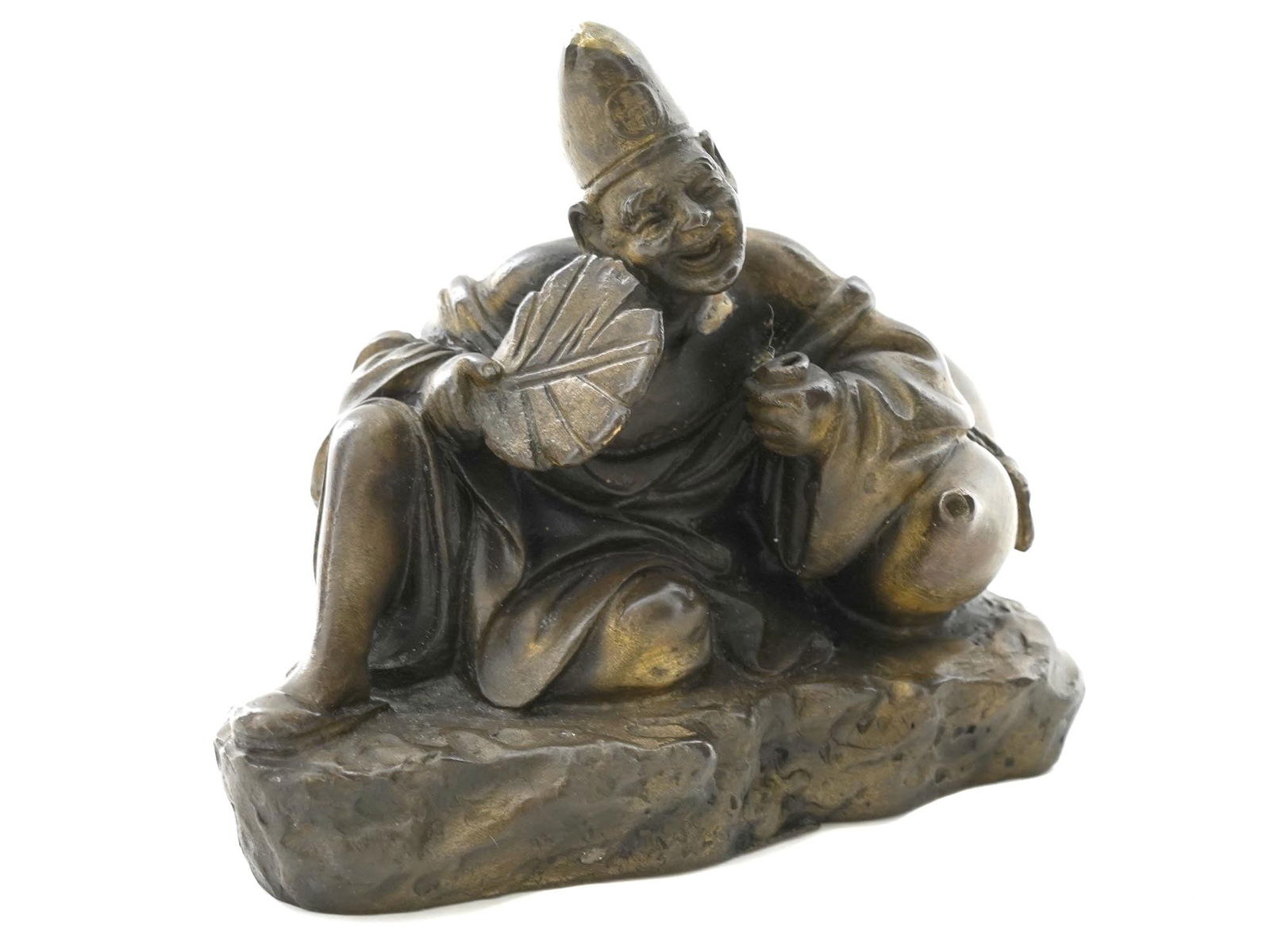 JAPANESE PATINATED BRONZE FIGURE OF TAOIST MONK: A vintage Japanese gilt patinated bronze figure of a cheerful Taoist monk. A figurine of a cheerful deity is a good gift, a talisman. He brings happiness and joy to the owner. The monk holds a fan tha