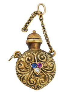 ANTIQUE 14 K GOLD RUBY DIAMOND SAPPHIRE BOTTLE CHARM: An antique Victorian 14K gold perfume bottle, circa the mid 19th century. The piece is modeled as a miniature vessel of a round shape, adorned with finely detailed hand carved floral patterns and set