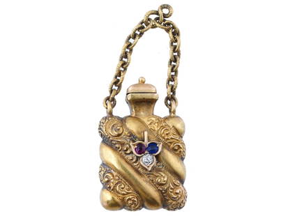 ANTIQUE 14 K GOLD RUBY DIAMOND SAPPHIRE BOTTLE CHARM: An antique Victorian 14K gold perfume bottle, circa the mid 19th century. The piece is modeled as a miniature vessel of a gadrooned square shape, adorned with fine hand carved patterns and set with a