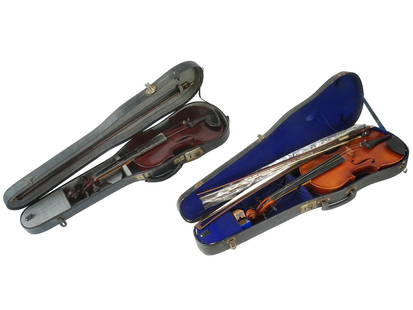 TWO ANTIQUE VIOLINS AND BOWS HOUSED IN CASES: A pair of antique violins, each housed in its own case and accompanied by four bows. The larger violin, sized at 4 of 4, boasts a carved portrait of the composer Wolfgang Amadeus Mozart adorning its b