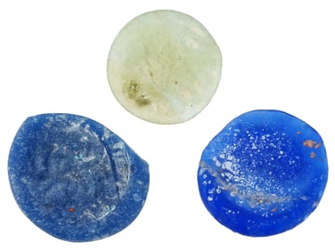 THREE ANCIENT ROUND GLASS TOKENS OF VARIOUS COLORS