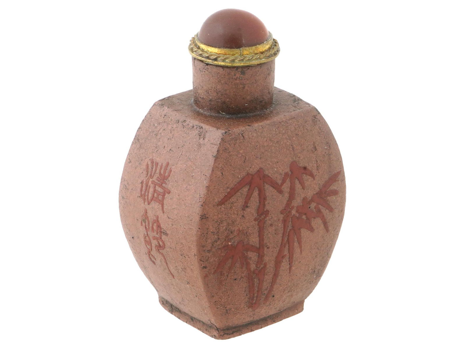 ANTIQUE CHINESE YIXING CLAY SNUFF BOTTLE 19TH C: An antique Chinese Yixing clay snuff bottle. The snuff bottle is decorated on one side with relief bamboo shoots, and on the other with sakura blossom branches. Completed with a carnelian stopper with