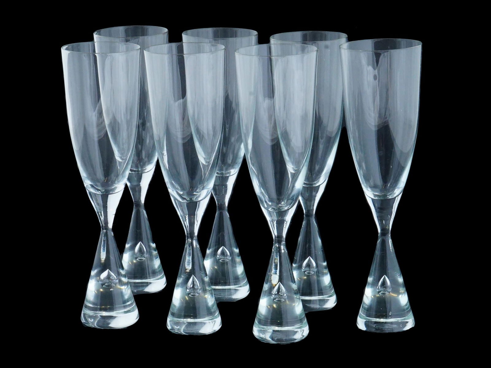 HOLMEGAARD PRINCESS GLASS CHAMPAGNE FLUTES SET: A set of vintage clear glass champagne flutes by Holmegaard Glass Factory, Denmark. Ca. 1986 to 1998. Princess collection. A total of 7 items. Air bubble stem of cone shape, no trim. Collectible Desig