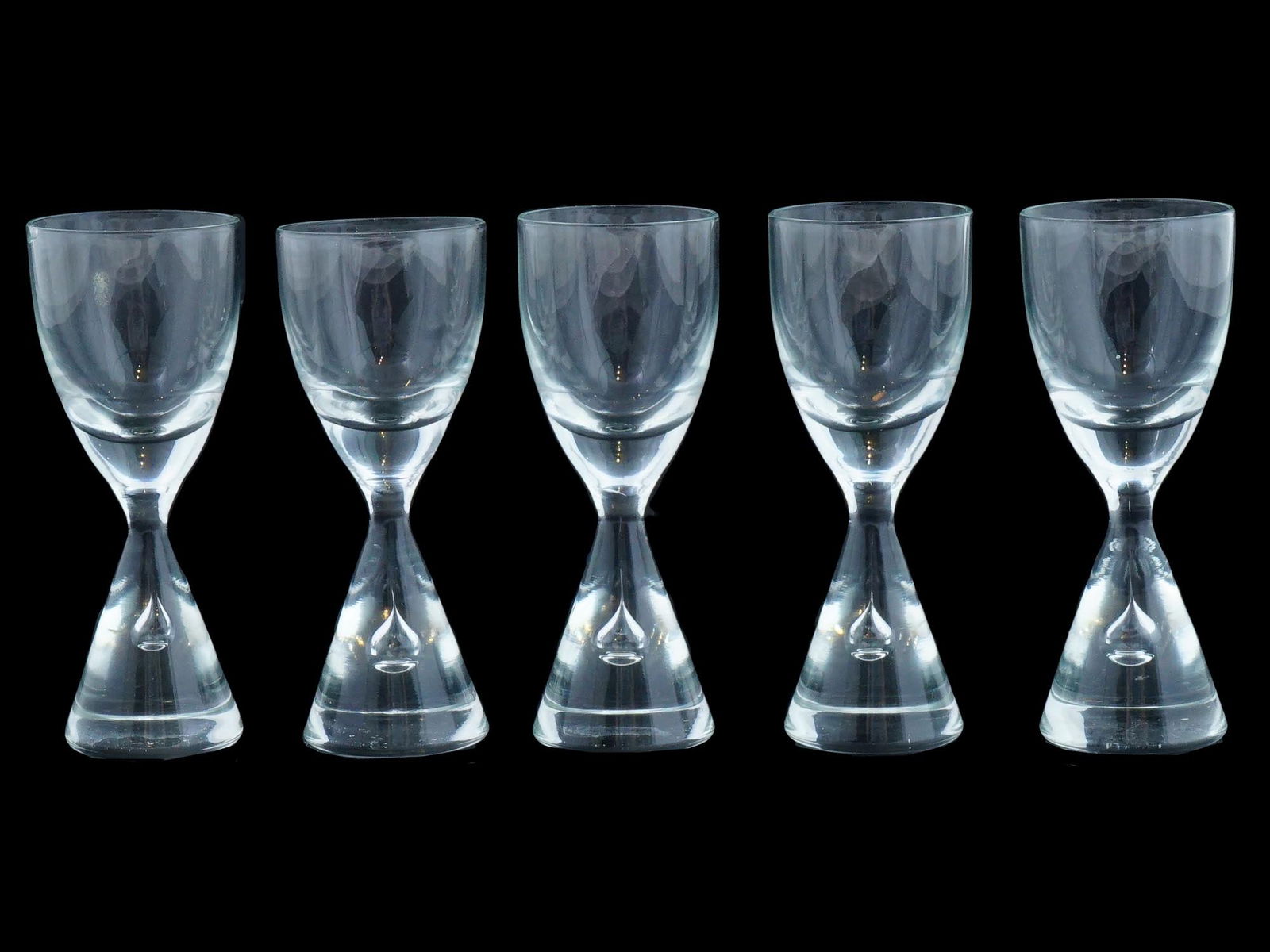 HOLMEGAARD PRINCESS CLEAR CORDIAL GLASSES SET: A set of vintage clear cordial glasses by Holmegaard Glass Factory, Denmark. Ca. 1986 to 1998. Princess collection. A total of 5 items. Air bubble stem of cone shape, no trim. Collectible Designer Gla