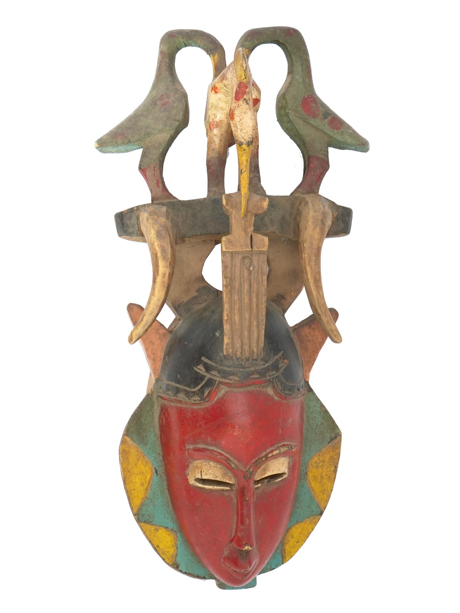VINTAGE GURO MASK FROM IVORY COAST OF AFRICA: A vintage Guro Mask from the Ivory Coast of Africa. The mask is colorful, painted in red, blue, and yellow colors. The face is oblong, with elongated cheeks and a narrow nose. The mask contains horns 