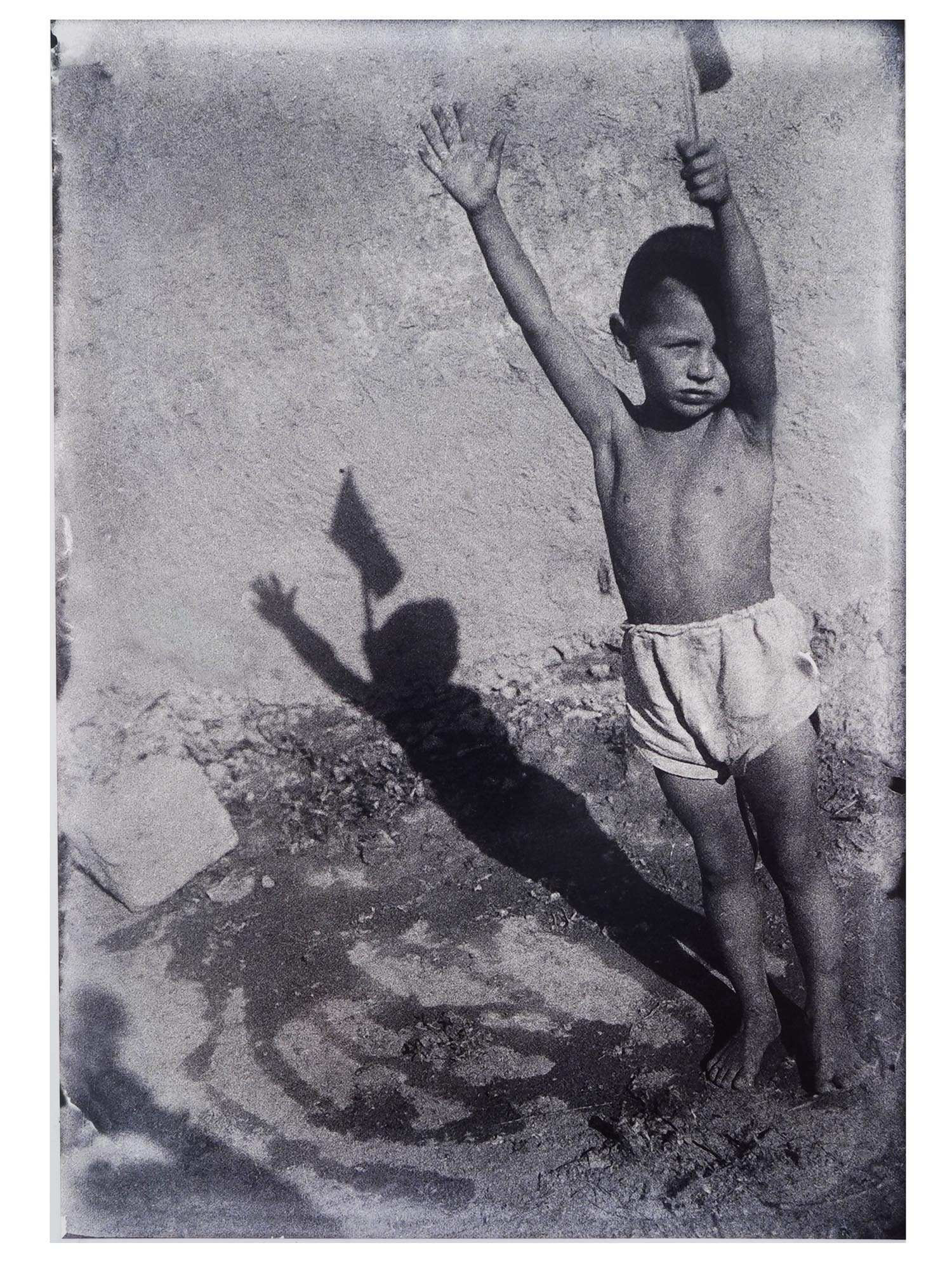 1920S UZBEK SOVIET ERA PORTRAIT PHOTO BY SEMEN MALT: Semen Adolfovich Malt, Uzbek, Soviet era, 1900 to 1968, black and white photograph, a Boy with a Small Flag, 1929. Printed in 1998 from a glass negative. Inscribed, titled, and dated, on the backside.