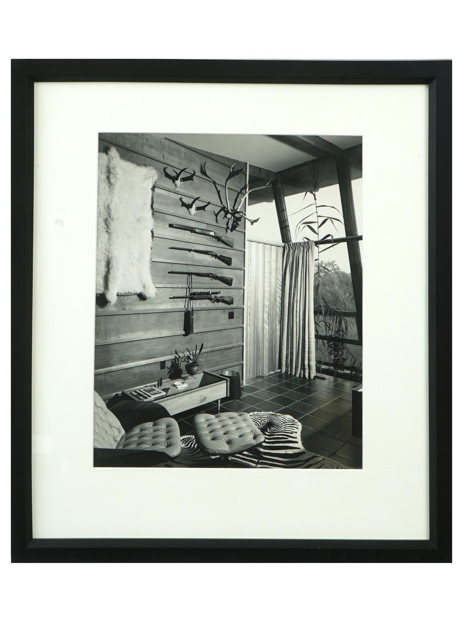 VINTAGE PHOTOGRAPH FROM MID 20TH C DEN IN AFRICA: A vintage photograph from the mid 20th century titled Den In Africa. Apparently the photo was taken by James Beard. Shown here is part of a room containing hunting trophies, including ungulate antlers