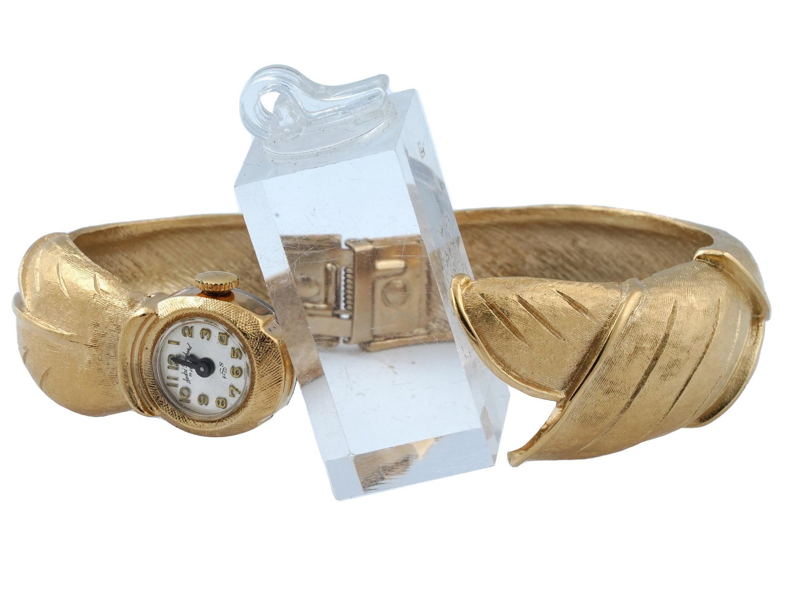 MIDCENT ANDRE BOUCHARD 17 JEWELS LADIES WRISTWATCH: An unusual ladies wristwatch by Andre Bouchard. Ca. 1960s. 17 Jewels, incabloc movement, PSS. Round white dial with Arabic numerals and hallmark. Single crown. Hinged gold-tone metal bangle bracelet o