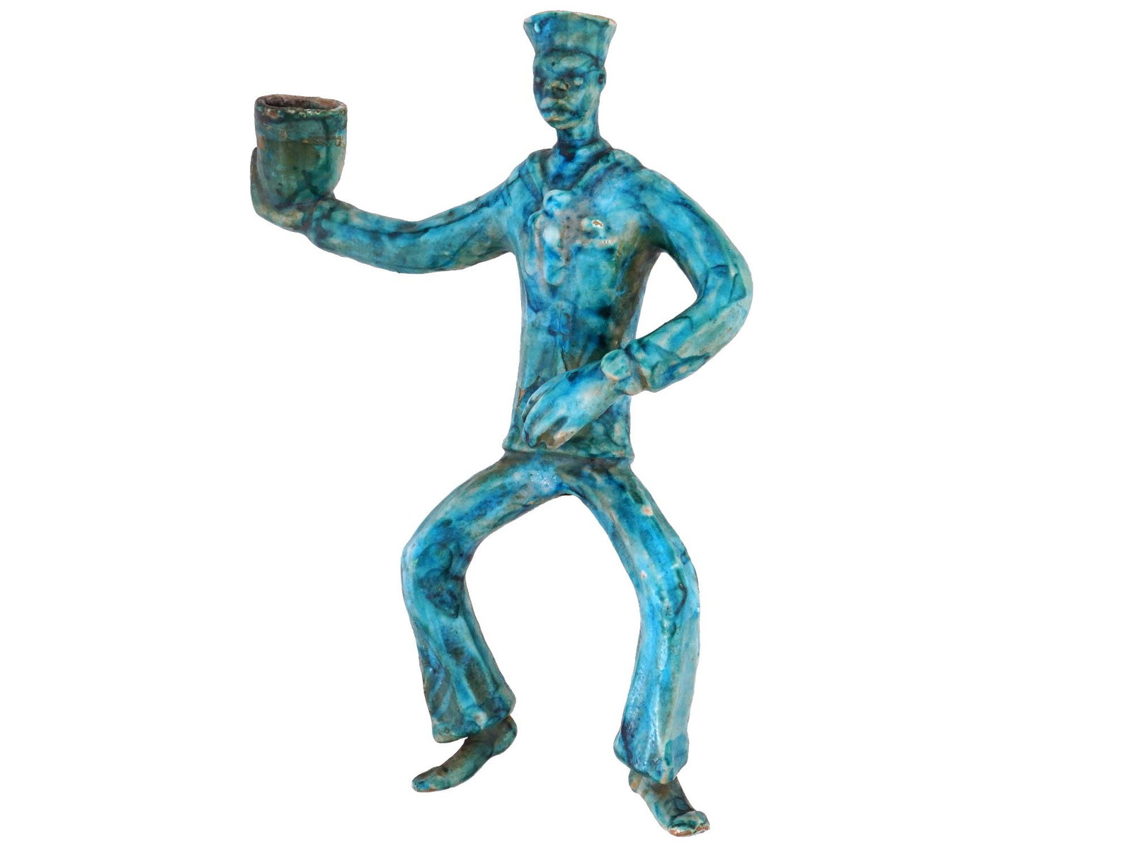 VINTAGE CERAMIC SAILOR WALL CANDLESTICK MID 20TH C: A vintage ceramic glazed Sailor wall candlestick. The blue glazed candlestick is modeled in the shape of a dancing sailor holding a bowl. On the reverse side, there is a hole for mounting to the wall.