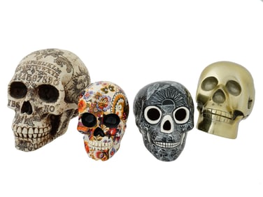 COLLECTION OF FOUR ENAMELLED DESIGN DECORATIVE SKULLS