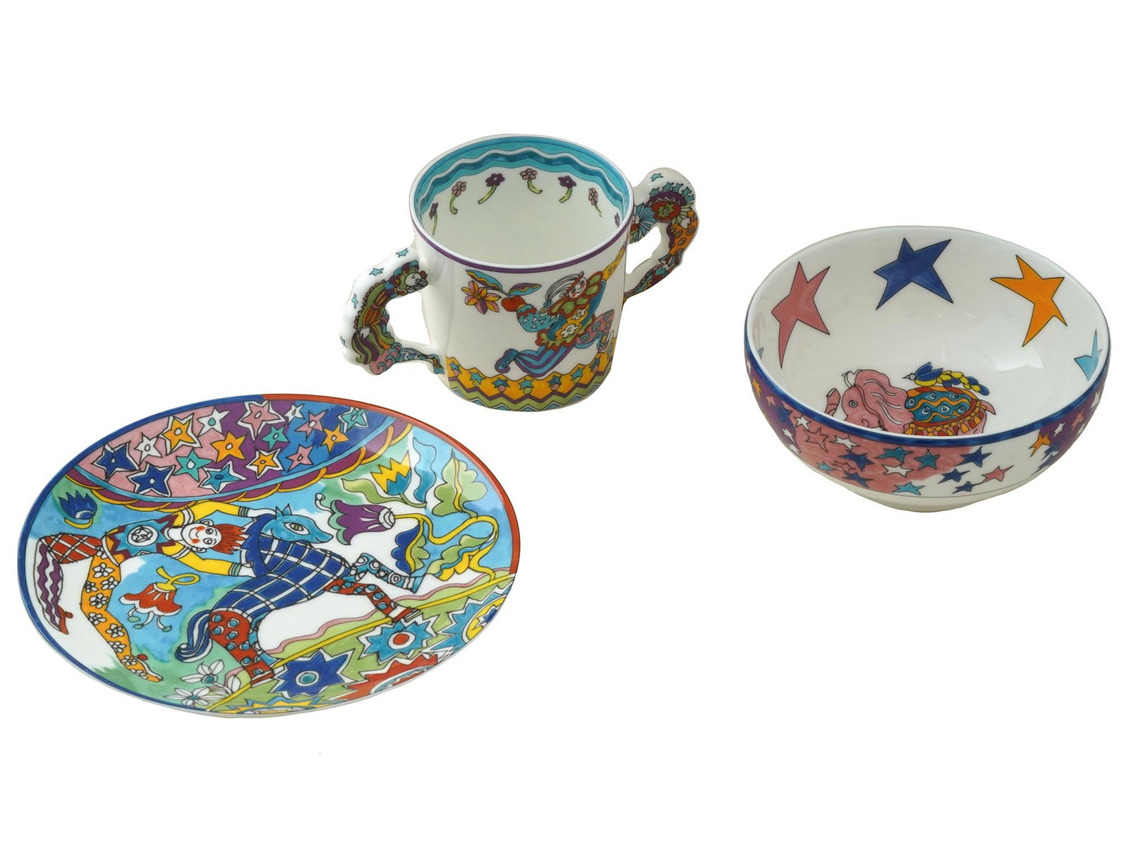 GENE MOORE F TIFFANY PORCELAIN SET CUP SAUCER BOWL: A lot of Gene Moore for Tiffany and Co porcelain set of a cup, saucer, and a bowl, 1997. The set, created for children, is decorated with bright paintings on the theme of the circus and clowns. Each w