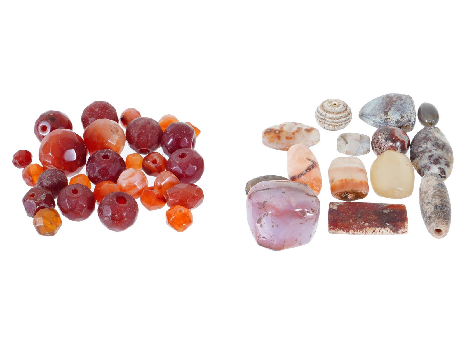 AGATE AND CARNELIAN BEADS OF VARIOUS FORMS AND DESIGNS: A diverse group of agate and carnelian beads, showcasing various forms and designs. The agate beads are distinguished by their ball-shaped design with faceted sides. Alongside these, the carnelian bea