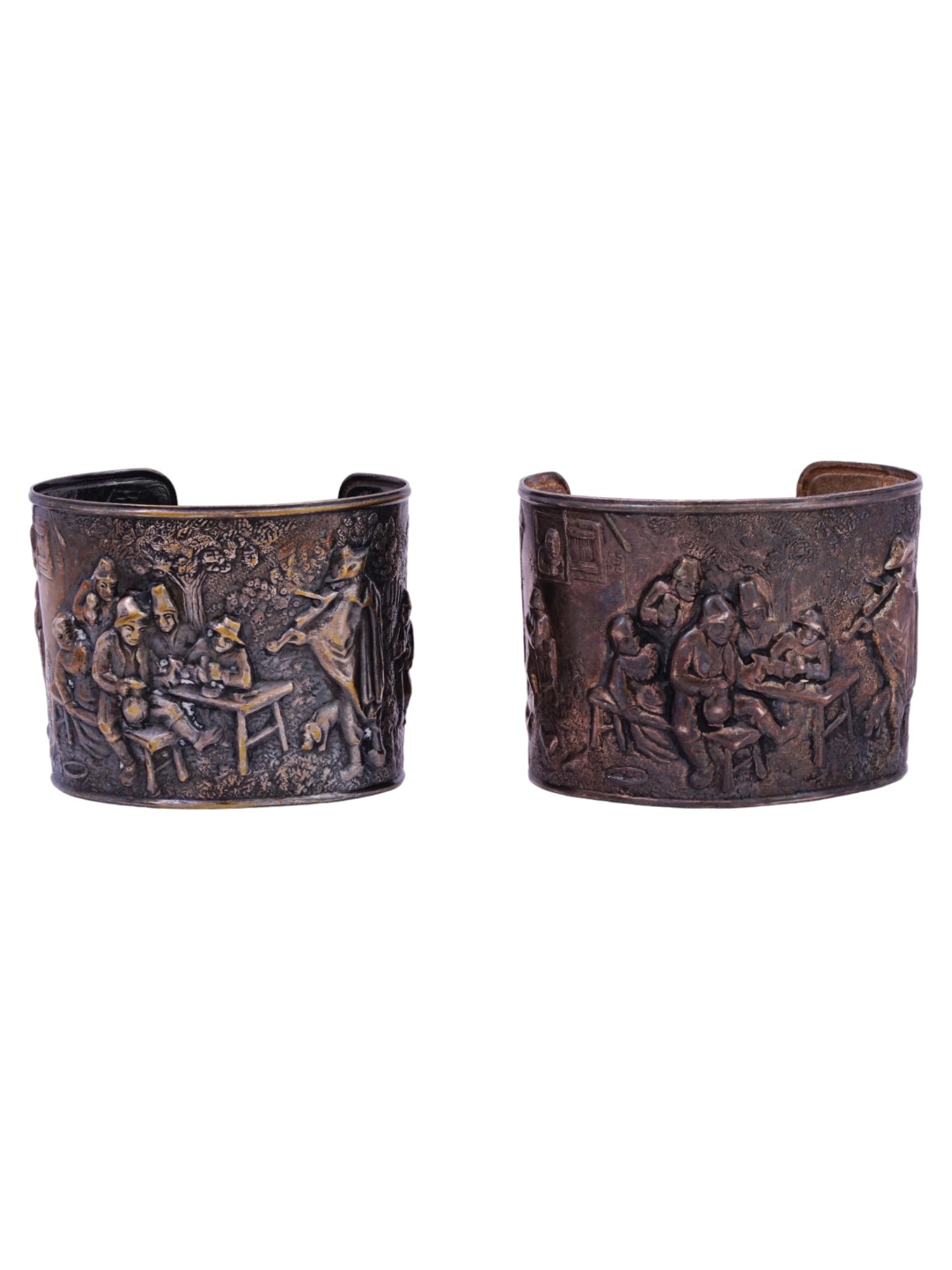 JORGEN STEFFENSON SILVER PLATED CUFF BRACELETS: A pair of identical vintage silver-plated cuff bracelets by Jorgen Th. Steffenson, a Danish silversmith active ca. 1960s to 1970s. Wide bracelets feature a repousse multi-figure tavern scene in Dutch