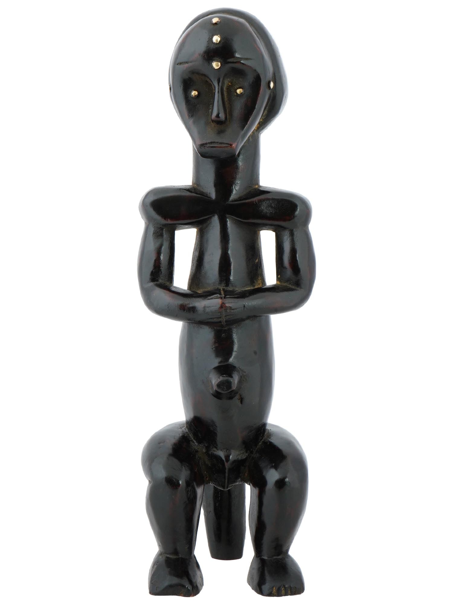 CENTRAL AFRICA GABON WOODEN FANG BYERI FIGURINE: A Central African Fang people Byeri reliquary figure from Gabon. Represents a male sitting figure with exaggerated physical features. Reliquaries serve as containers for sacred objects and ancestral r