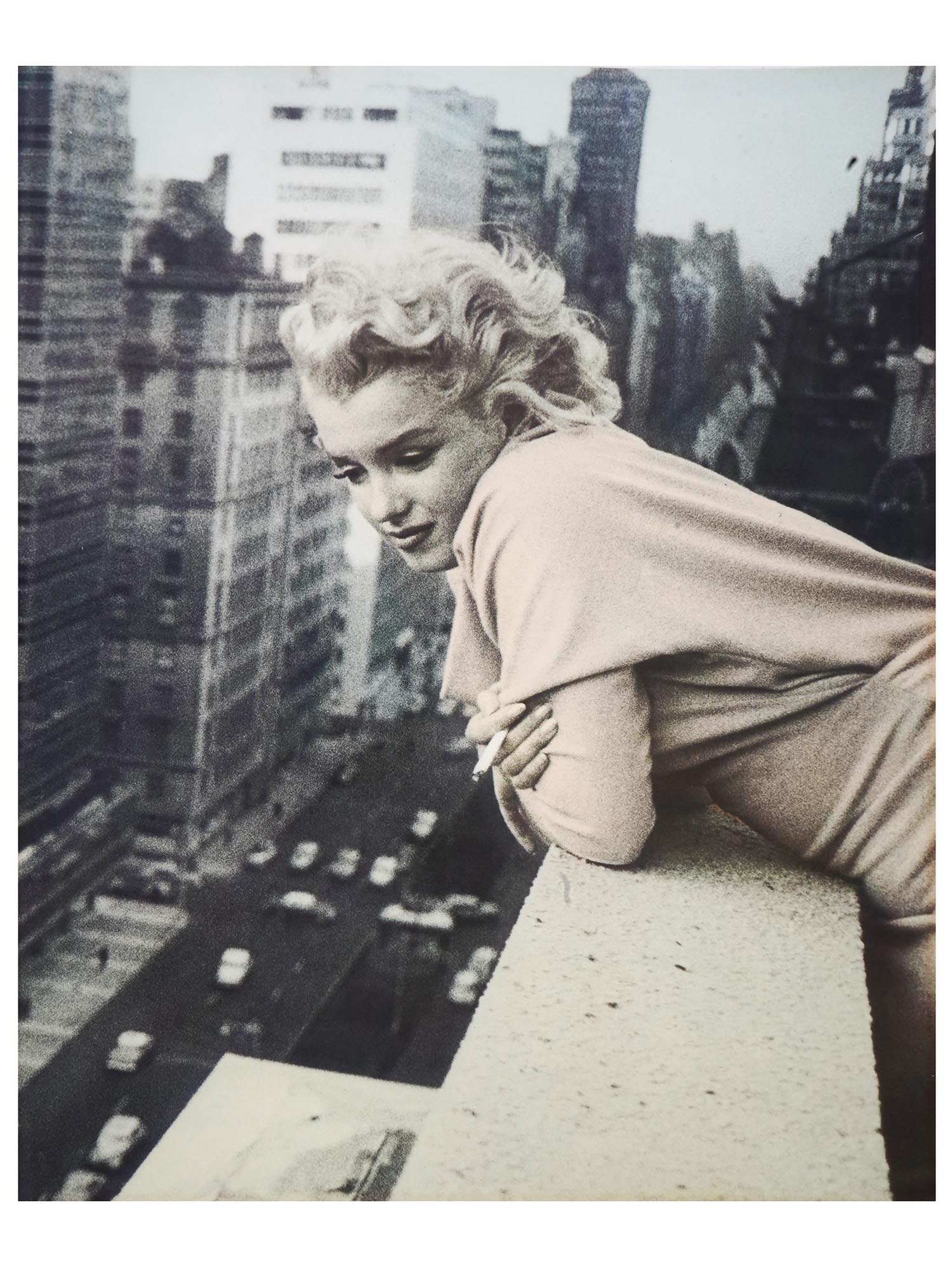 ED FEINGERSH MARILYN MONROE ON THE ROOFTOP PHOTO: Ed Feingersh, 1925 to 1961, a silver gelatin print depicting Marilyn Monroe leaning over the balcony of the Ambassador Hotel in March 1955 in New York City. Ed Feingersh studied photography under Alex
