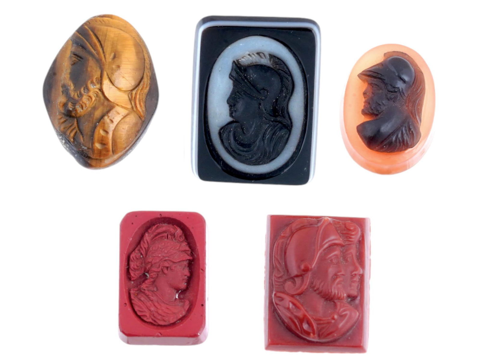 ANTIQUE HAND CARVED TIGER EYE INTAGLIO COLLECTION: A collection of antique Roman manner intaglios, featuring a variety of shapes and intricately carved stone portraits of soldier profiles. One is a hand carved Tiger eye stone. These exquisite pieces,