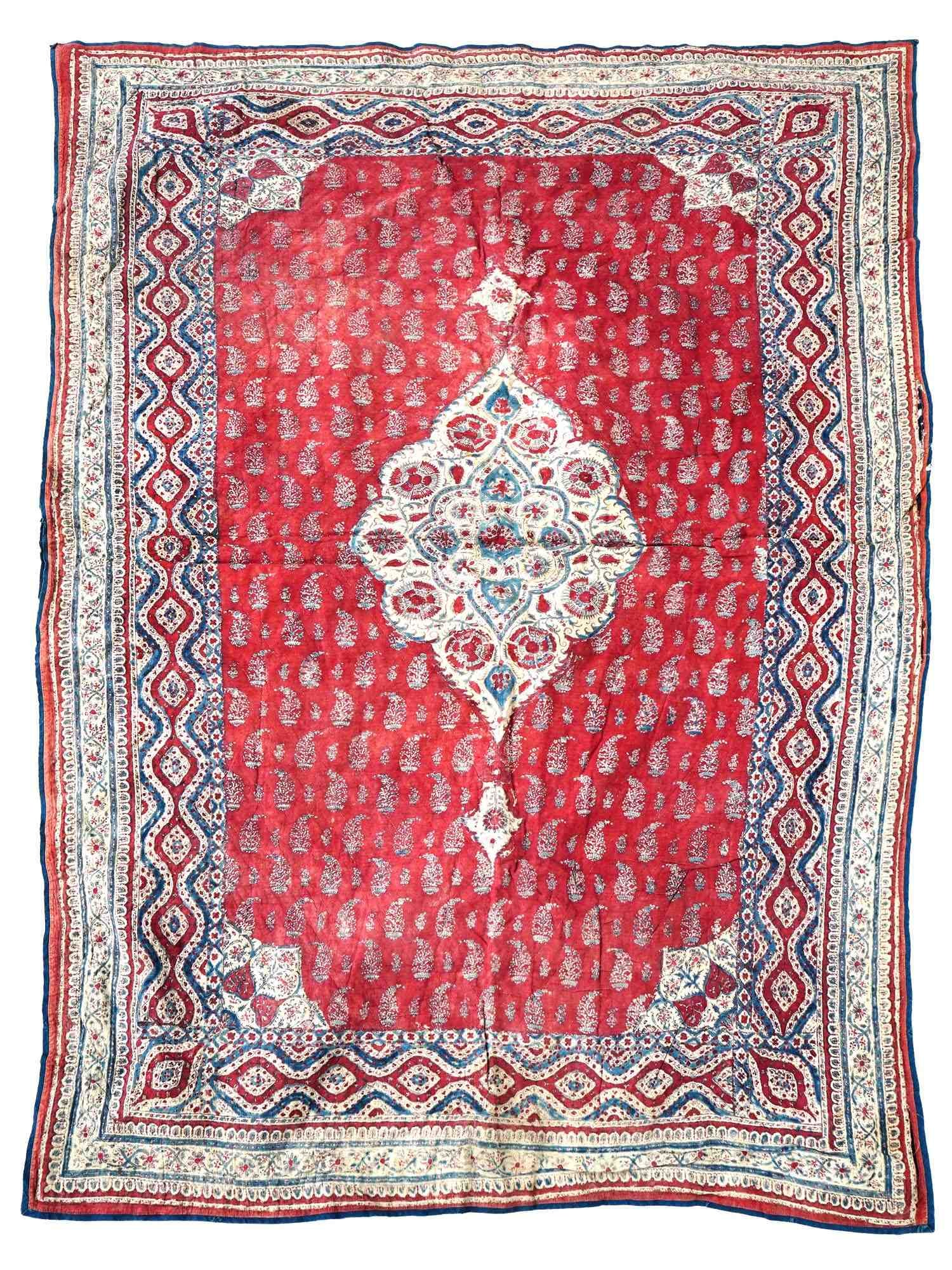 CLASSIC ANTIQUE PERSIAN KALAMKARI COTTON TEXTILE: An antique Persian Kalamkari cotton textile. The textile is adorned with an ornamental medallion in the center, and traditional polychrome floral, foliage, and paisley patterns. The backside is decora