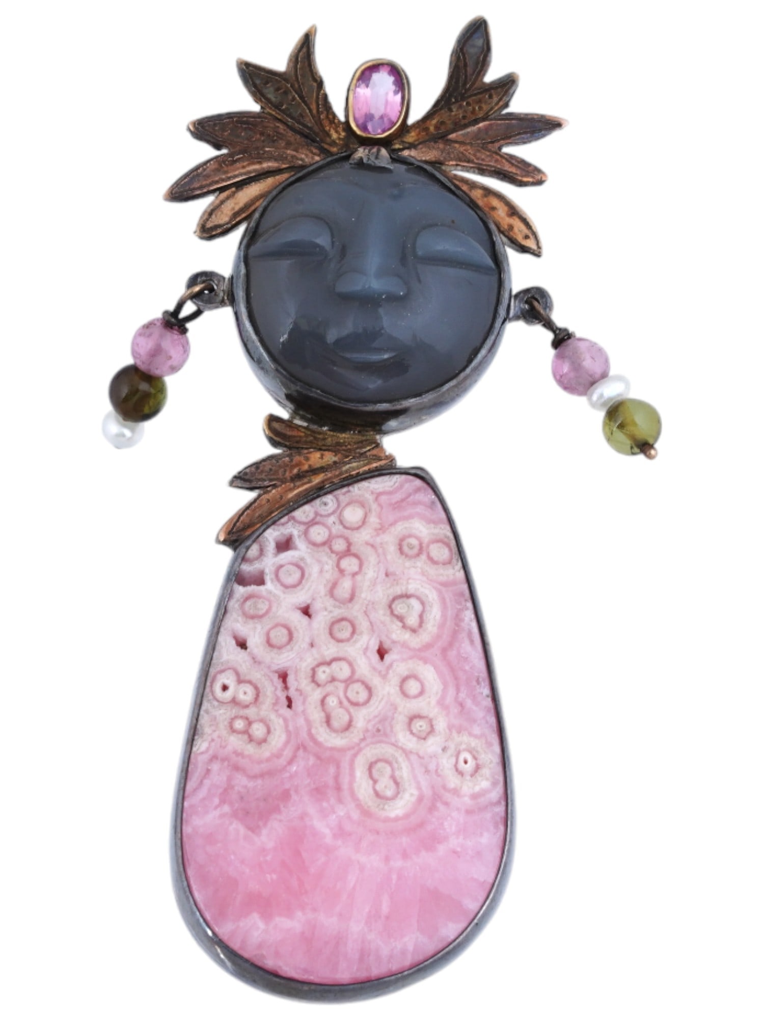 VINTAGE PAT GARRETT ST SILVER GOLD RHODOCHROSITE BROOCH: A vintage sterling silver and gold brooch with a baby face and pink rhodochrosite stone by Pat Garrett. The brooch is modeled after a swaddled baby. The head is decorated with feathers with an oval pi