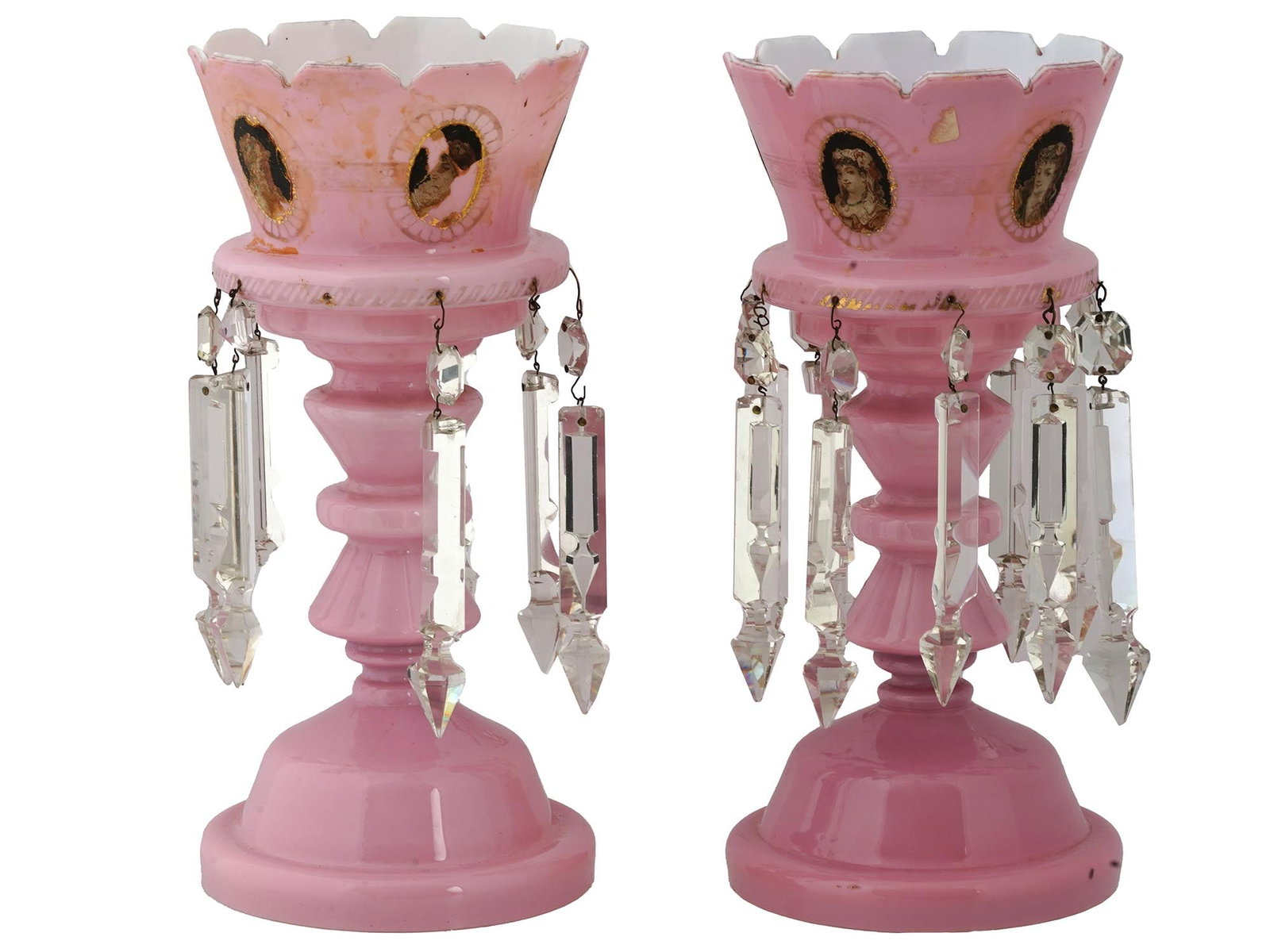 ANTIQUE VICTORIAN BOHEMIAN PINK GLASS MANTLE LUSTERS: A pair of antique Victorian Bohemian pink overlay glass mantle luster candle holders. Each candleholder is adorned with elegant cut spear prisms. The lusters are further decorated with hand-painted fe