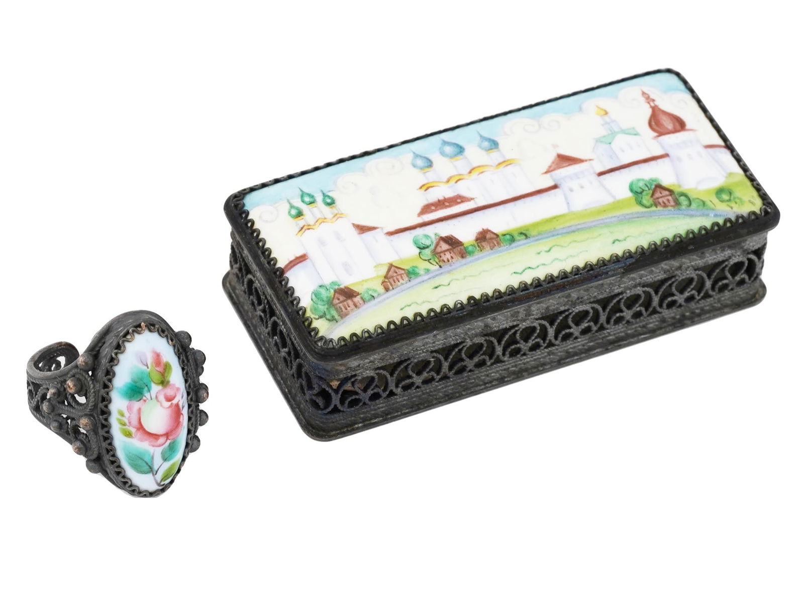 RUSSIAN HAND PAINTED ENAMEL FILIGREE PILLBOX AND RING: A vintage Russian enameled pill box and ring adorned with filigree designs. The pill box features a hand-painted image of a Russian landscape with church motifs, surrounded by intricate filigree on th