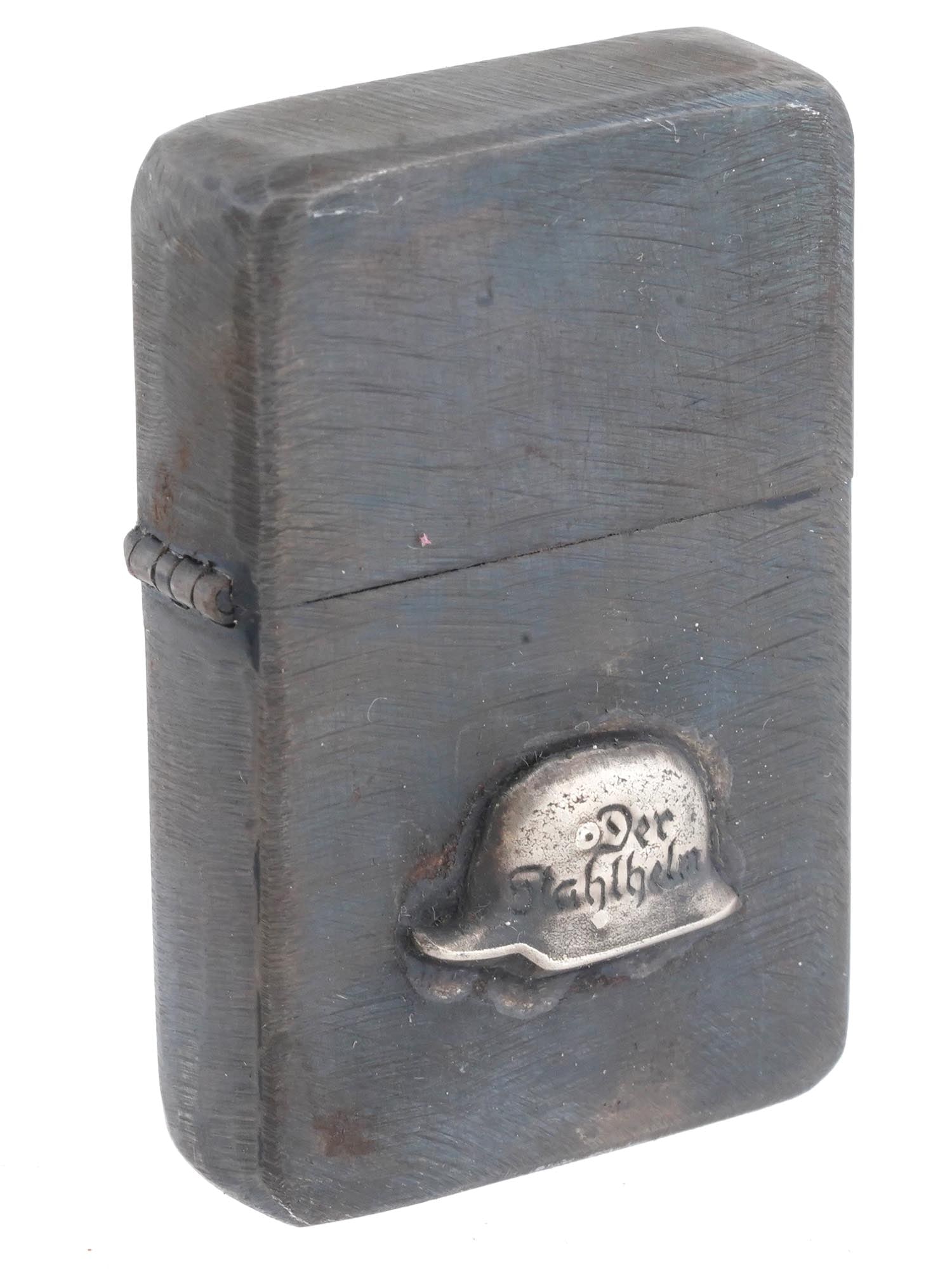 WWII NAZI GERMAN VETERANS HELMET CIGARETTE LIGHTER: A WWII Nazi German Third Reich The Steel Helmet League of Front Line Soldiers model veterans organisation military pocket cigarette lighter. Stainless steel body decorated with an overlay representing