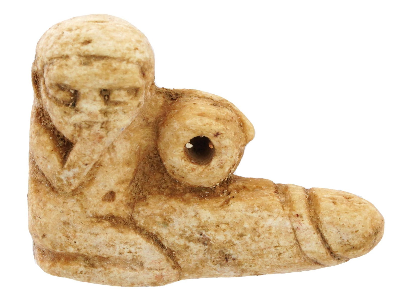 EGYPTIAN HAND CARVED NATURAL MATERIAL EROTIC PENDANT: A Egyptian hand carved from natural material figural pendant made in the ancient manner. The pendant represents an erotic figure, carved with detailed patterns. An opening for wearing to the center ri
