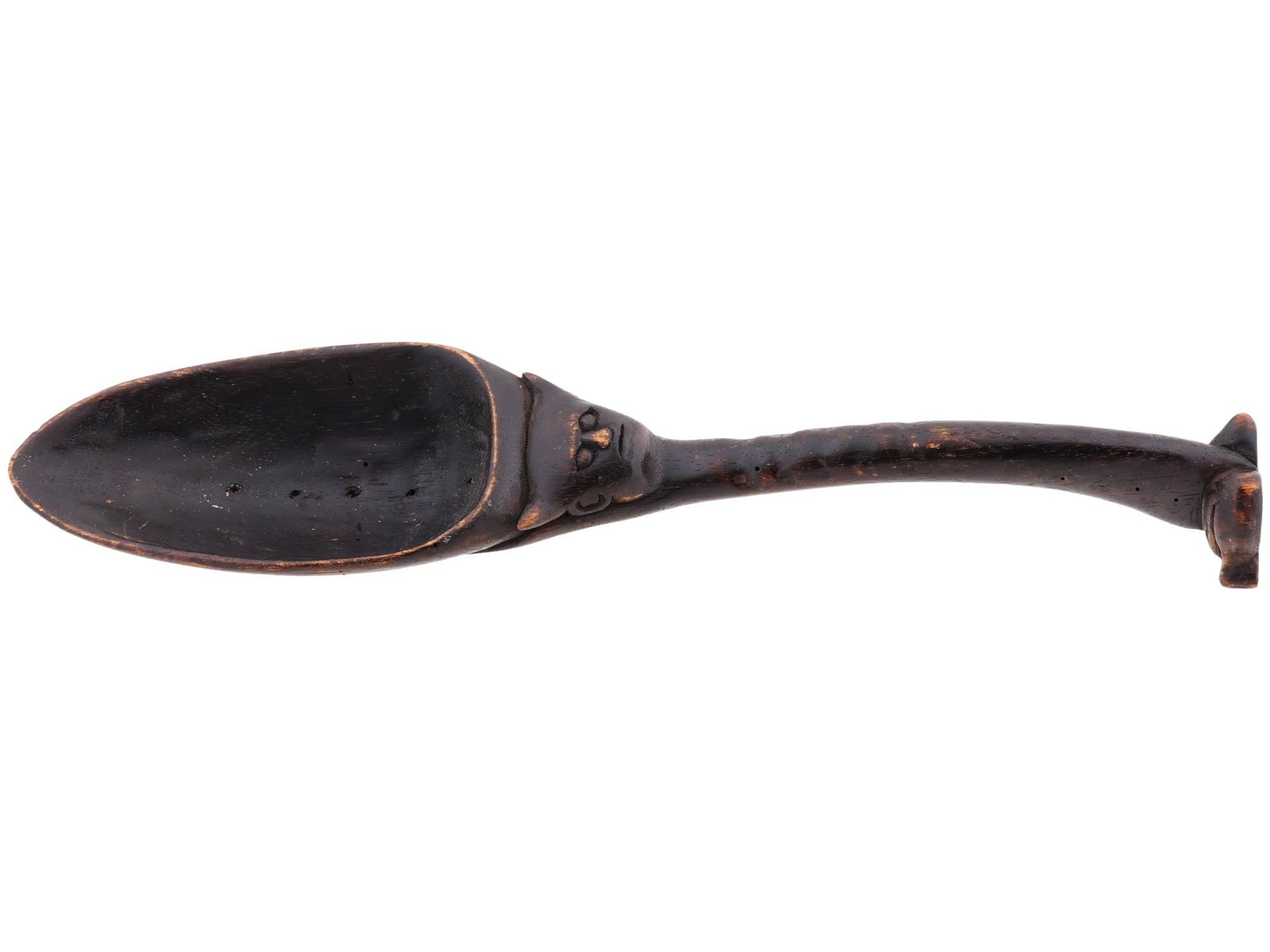 ANTIQUE AFRICAN ETHNOGRAPHIC WOODEN SPOON C 1920: An antique African tribal spoon hand carved of wood. On the obverse, the neck has a relief head of a man with horns. The bowl is carved with an image of a lizard. Slightly curved stem. The spoon can s