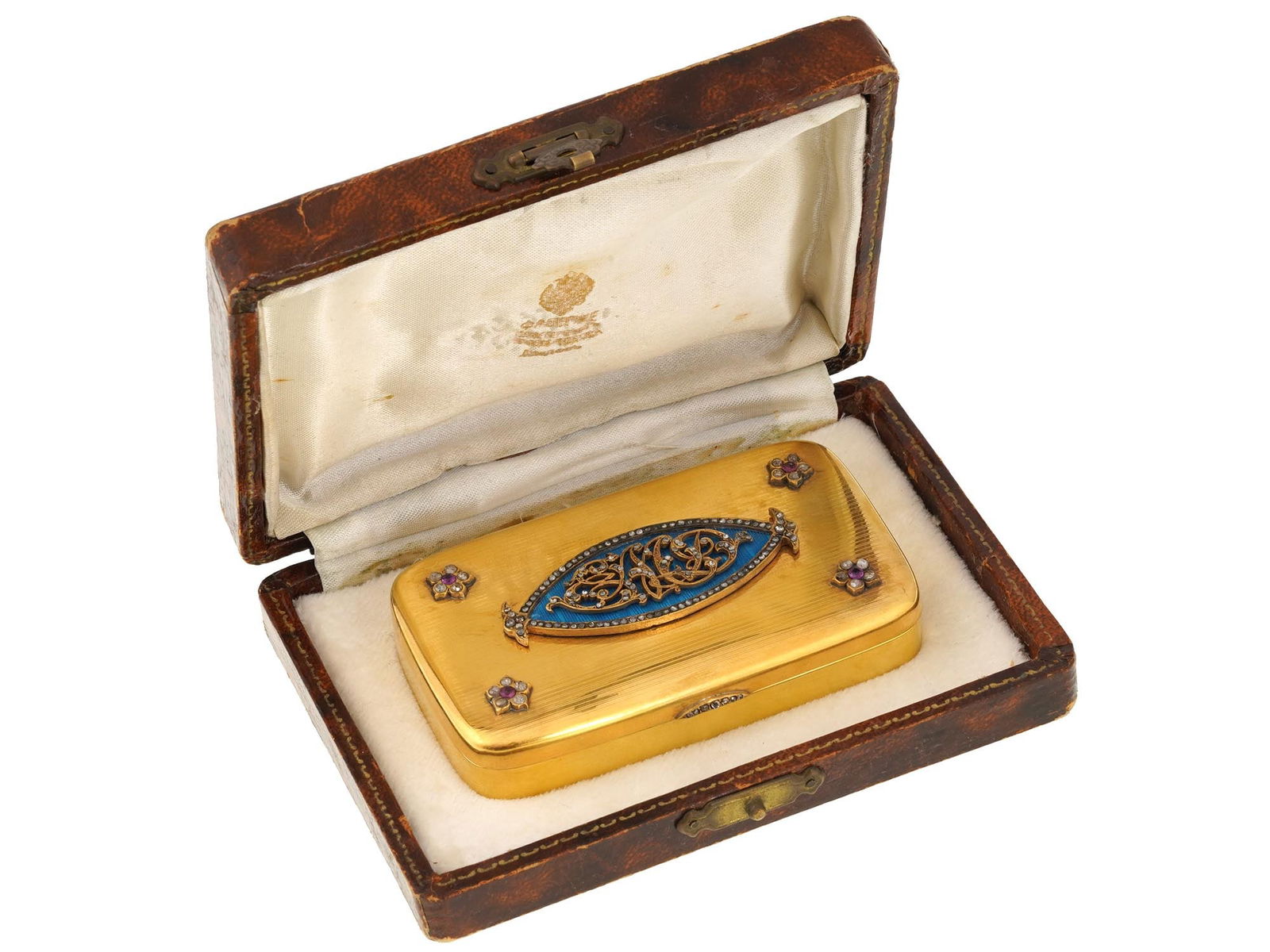 RUSSIAN GILT SILVER ENAMEL SNUFF OR PILL BOX: A fine Russian gilt silver enamel snuff or pill box. The gilt silver exterior is adorned with an applied relief monogram over a blue enamel ground. Set with gemstones, presumably, diamonds and rubies.