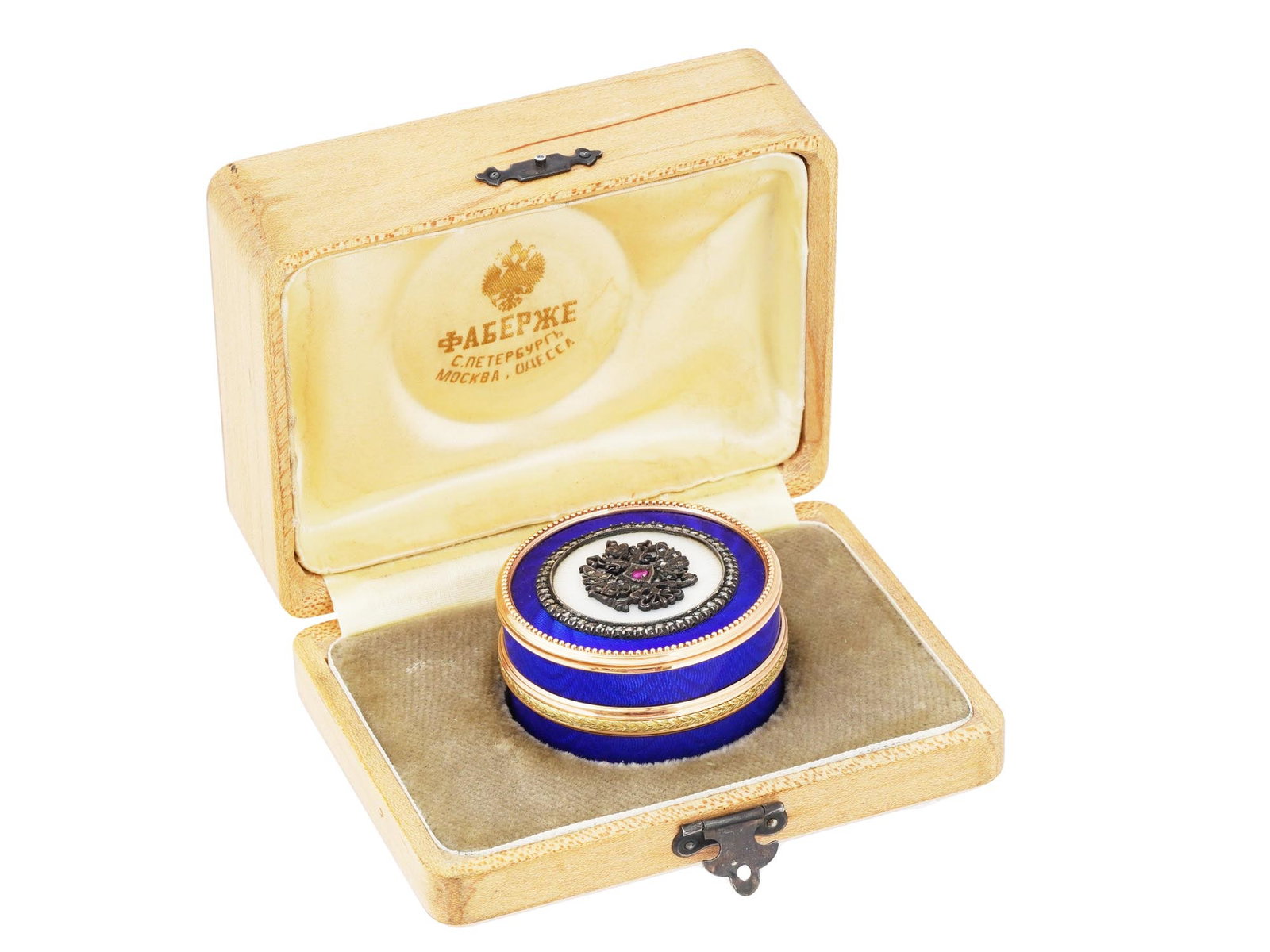 RUSSIAN 56 GOLD ENAMEL DIAMOND AND RUBY PILL BOX: A Russian 56 gold lidded pill box of a round form. The exterior is covered with a cobalt blue enamel over a guilloche ground with engraved patterns. The matched lid is covered with cobalt blue and whi