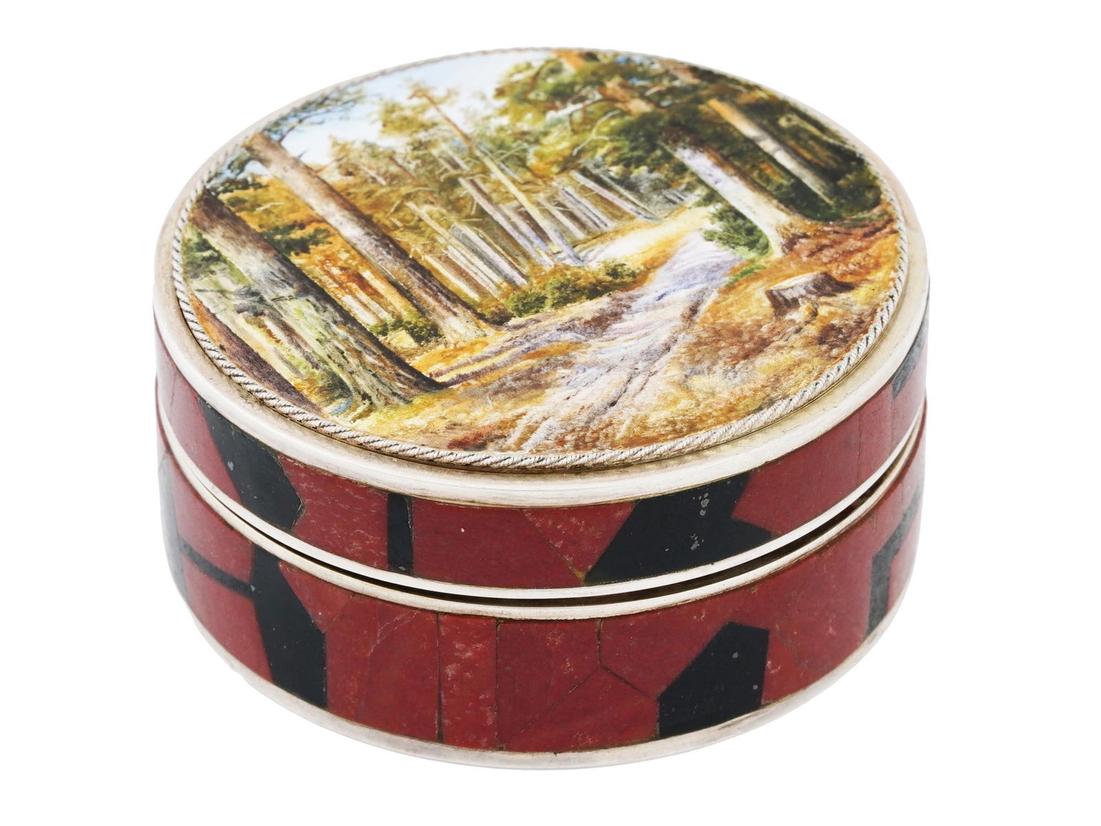 RUSSIAN GILT SILVER PILL BOX WITH MINIATURE PAINTING: A Russian round silver pill box with hinged lid. The exterior is decorated with red and black mosaic. The enameled lid is embellished with a miniature painting which depicts a forest landscape. Hallma
