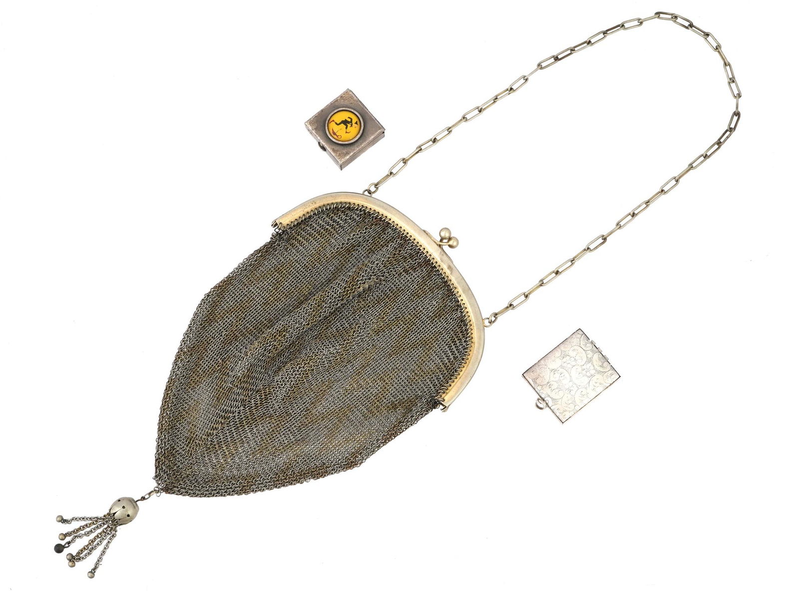 LOT OF 3 VINTAGE SILVER PLATED ITEMS C 1960S: The lot includes a silver plated theatrical mesh purse, a pill box with a hinged lid decorated with a round medallion depicting a man jumping over a candle and a photo locket adorned with engraved flo