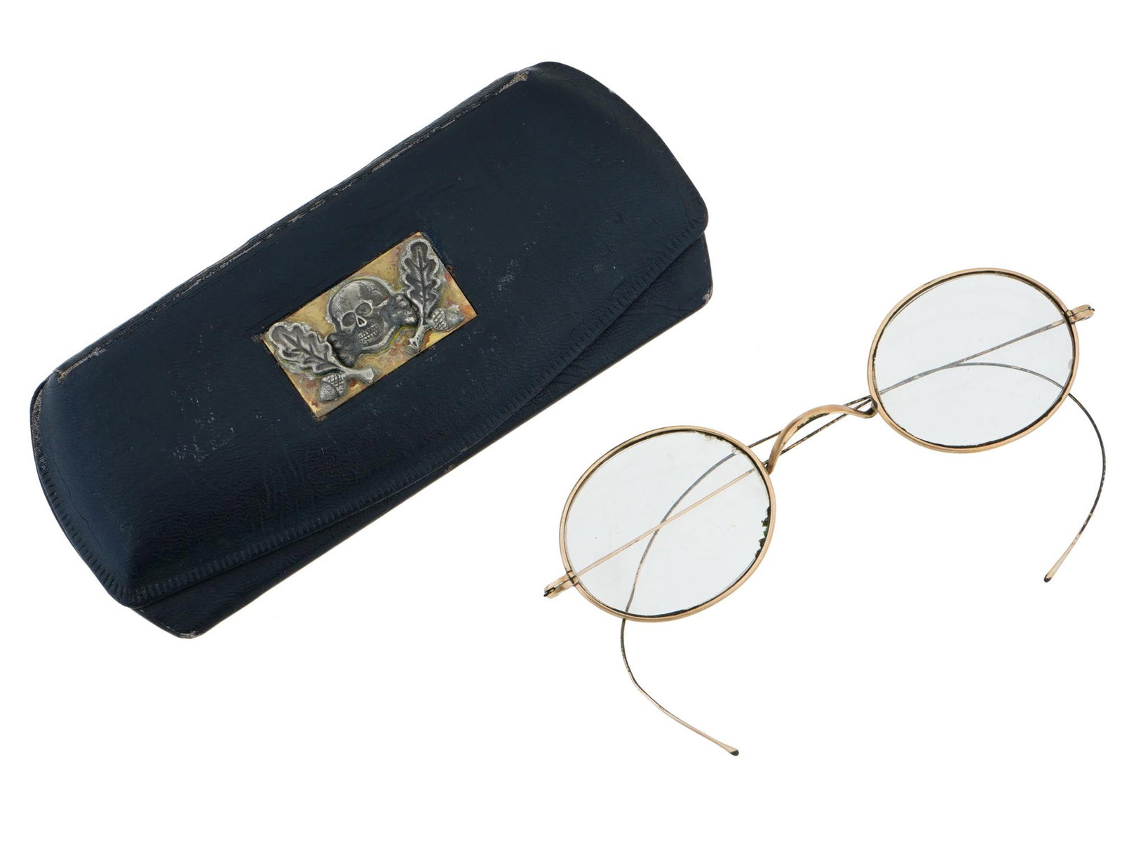 GERMAN WWII TYPE WAFFEN SS GLASSES WITH CASE: A WWII type Nazi German Third Reich Waffen SS Totenkopf glasses with a leather case lined with felt inside. The exterior of the case is adorned with a gilt metal plaque depicting a Totenkopf skull swa