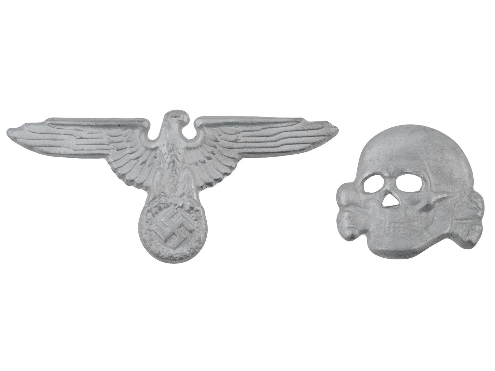 WWII TYPE NAZI GERMAN SET BADGES FOR SS VISOR HAT: A WWII type Nazi German Third Reich set of two badges for a SS visor hat. The badges are made in the shape of a Totenkopf skull and an eagle swastika insignia. Marked with Ges Gesch and RZM marks, on 