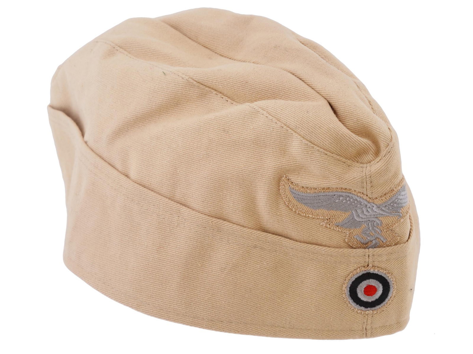 WWII TYPE GERMAN LUFTWAFFE TROPICAL OVERSEAS CAP: A WWII type Nazi German Luftwaffe EM NCOs tropical overseas cap. Constructed of a tan-coloured light cotton twill material and fully surrounded by fold-down side panels. Stitched onto the peak is an i