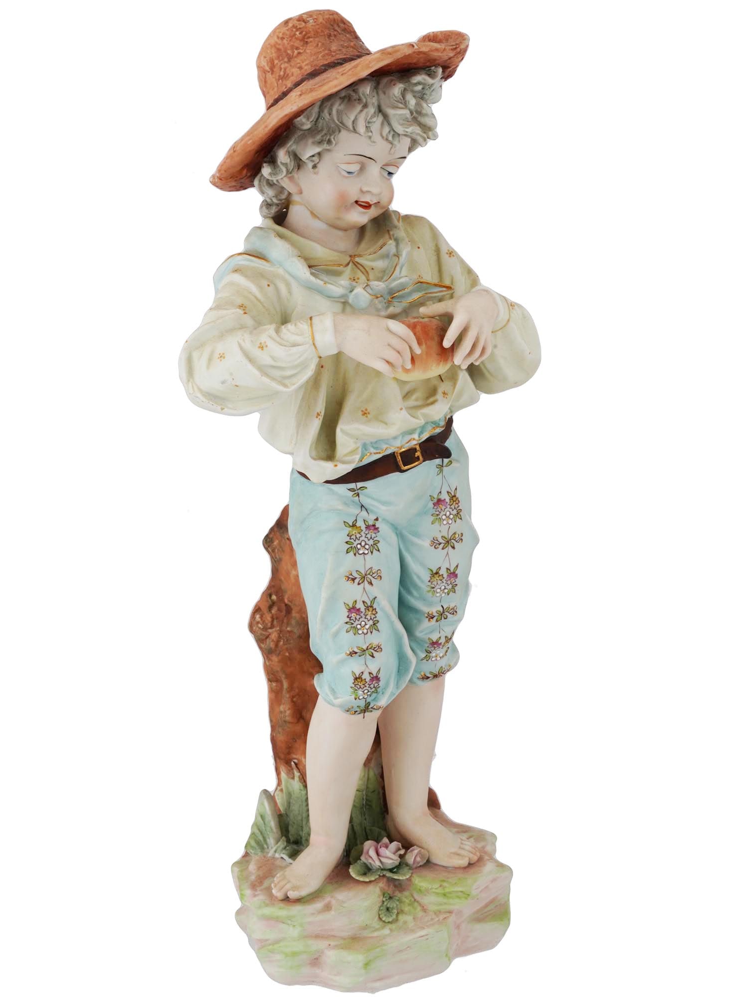 MID CENTURY GERMAN KALK PORCELAIN BOY FIGURINE: A mid-20th-century hand-painted porcelain figurine by Kalk, a German manufacture that functioned in the period since 1900 until 1972. The figure represents a peasant boy with a loaf of bread. Signed J