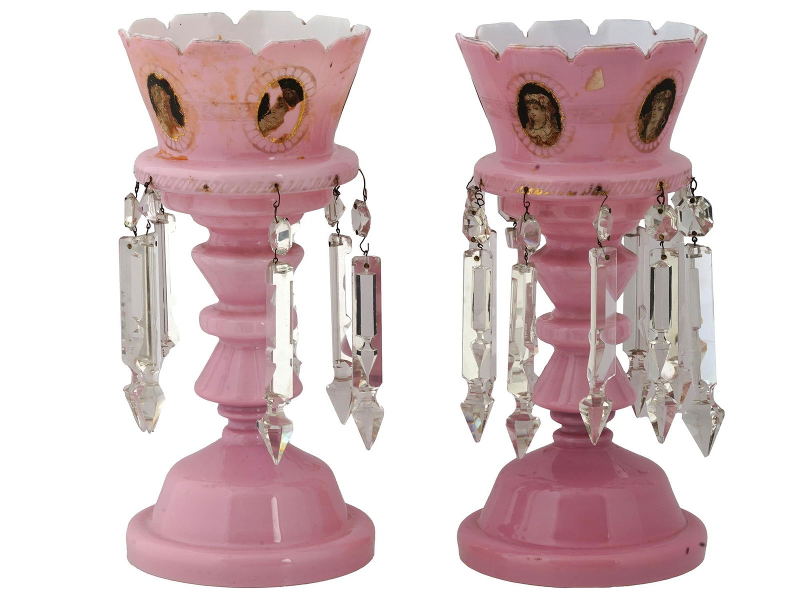 ANTIQUE VICTORIAN BOHEMIAN PINK GLASS MANTLE LUSTERS: A pair of antique Victorian Bohemian pink overlay glass mantle luster candle holders. Each candleholder is adorned with elegant cut spear prisms. The lusters are further decorated with hand-painted fe