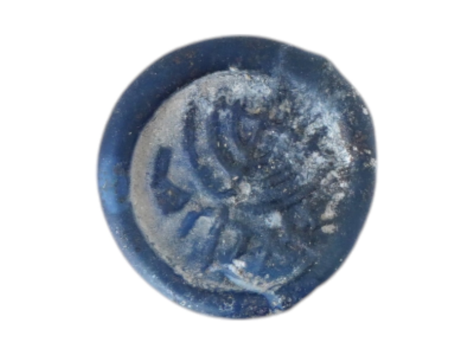 ANCIENT GLASS MEDALLION WITH MENORAH 200 TO 400 AD: An ancient glass medallion in dark blue shades showcasing a relief image of a menorah. Dating from 200 to 400 AD. The piece highlights the iconic seven branched candelabrum, a symbol of enduring signi