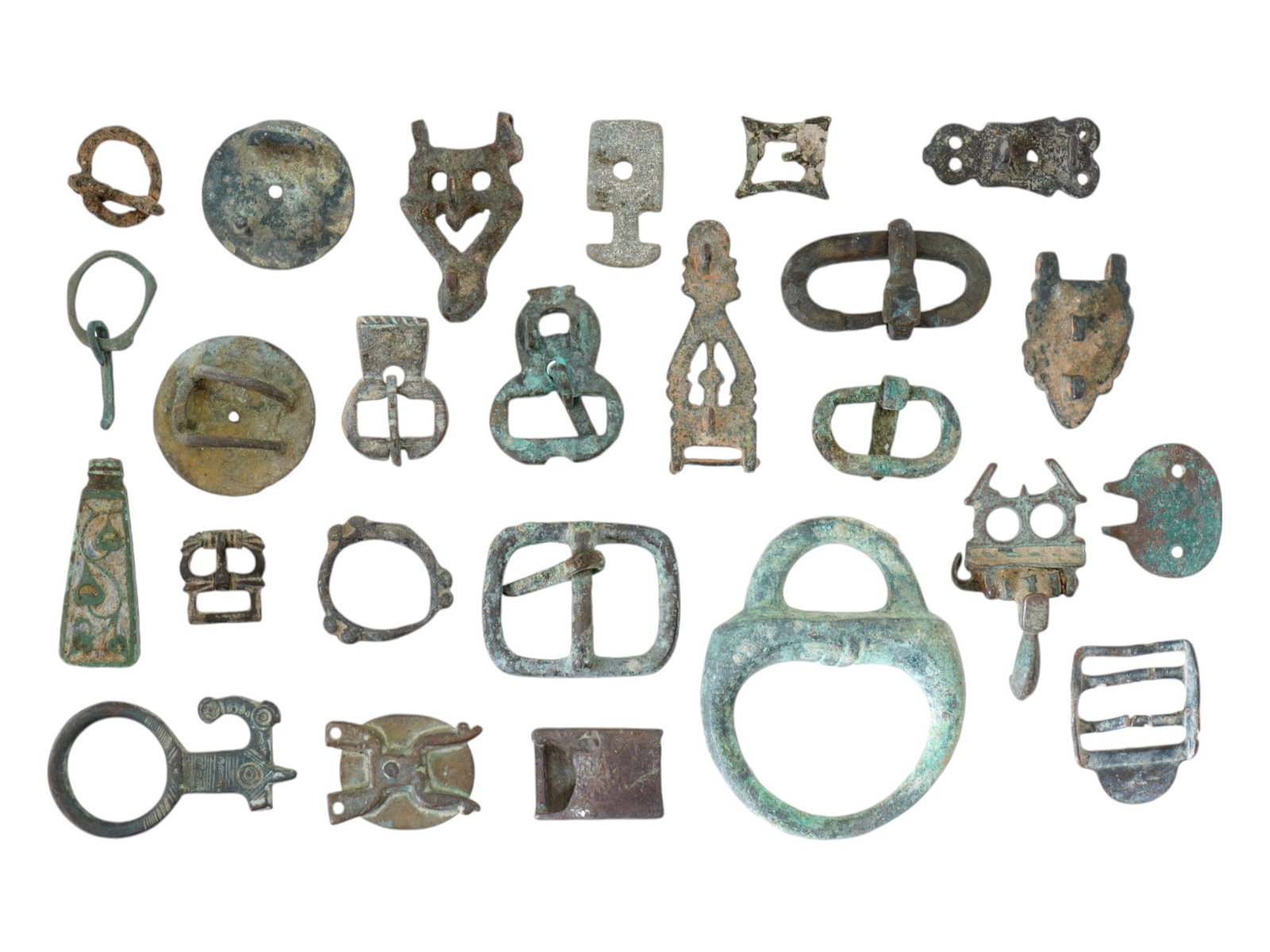 COLLECTION OF ANCIENT BRONZE BUCKLES 600 BC TO 500 AD: A collection of ancient bronze buckles in various styles and sizes, dating from 600 BC to 500 AD. Some feature engraved decorations, as well as foliage and geometric patterns. Antique Belt Buckles And