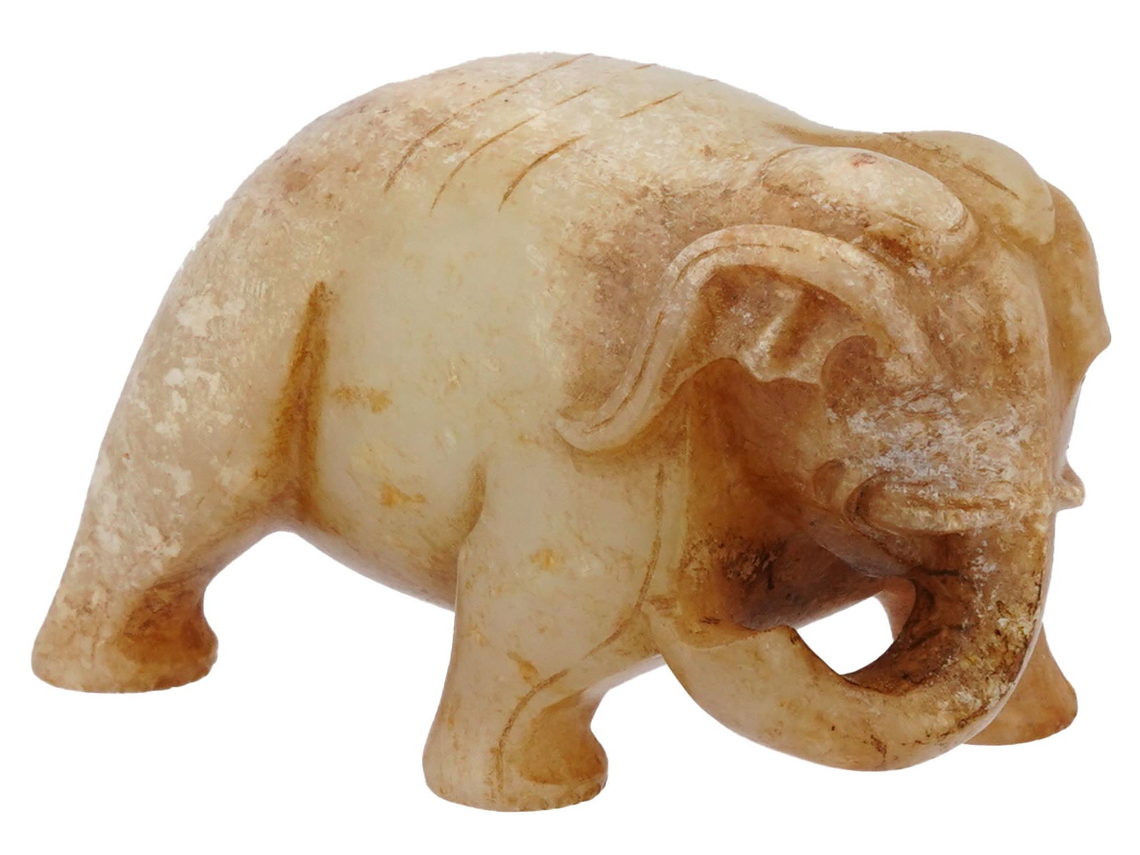 CHINESE CARVED HONEY JADE FIGURINE OF ELEPHANT: A vintage Chinese hand carved honey Jade amulet figurine. The figurine represents an elephant, engraved with detailed patterns. Circa: the first half of the 20th century. Antique and Vintage Asian and