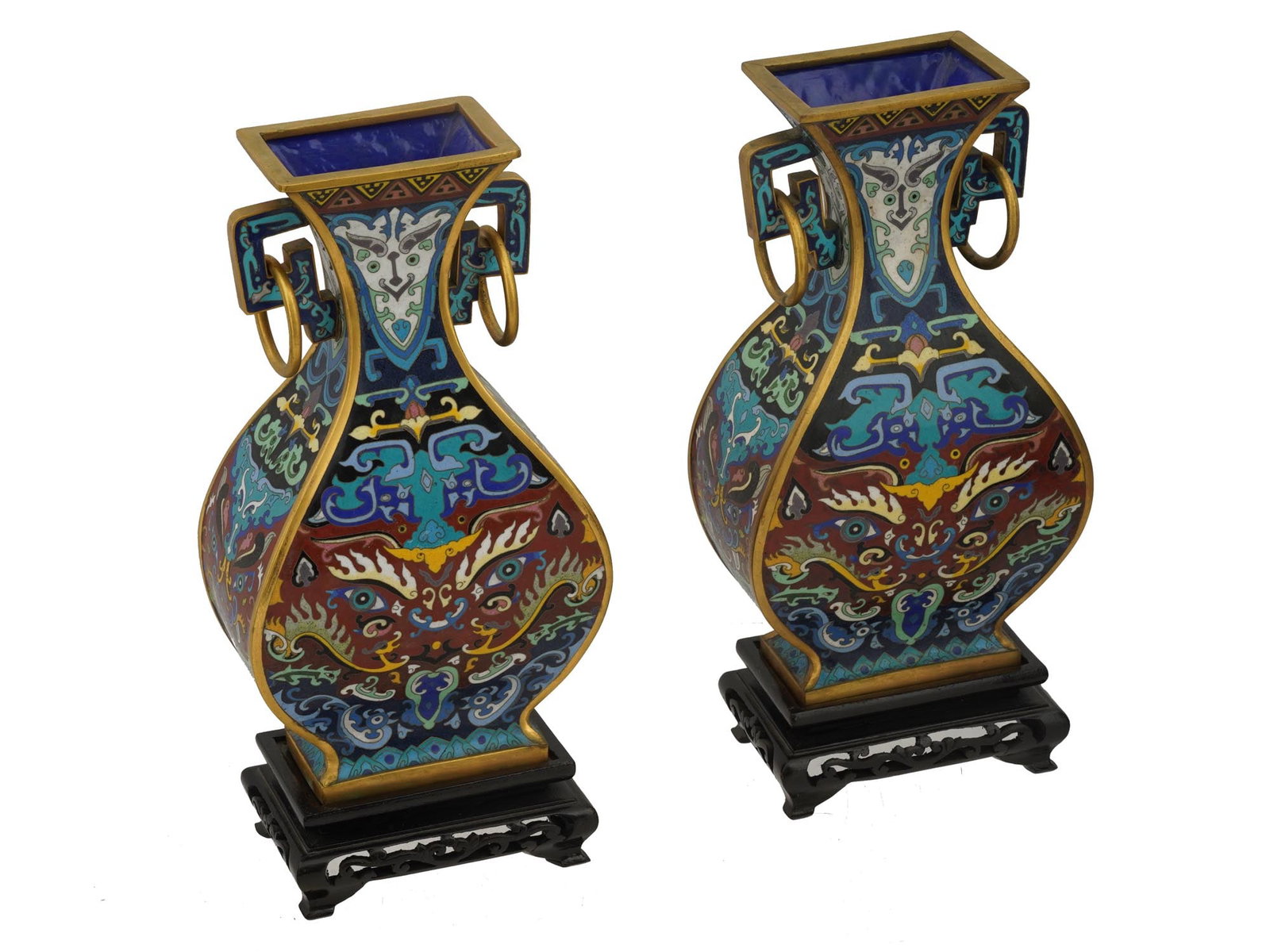 VINTAGE CHINESE CLOISONNE TAOTIE VASES OF SQUARE FORM: A pair of vintage Chinese cloisonne taotie vases featuring a square form and is adorned with intricate multicolored ornamentation. The vases showcase traditional Taotie mask designs, symbolizing power