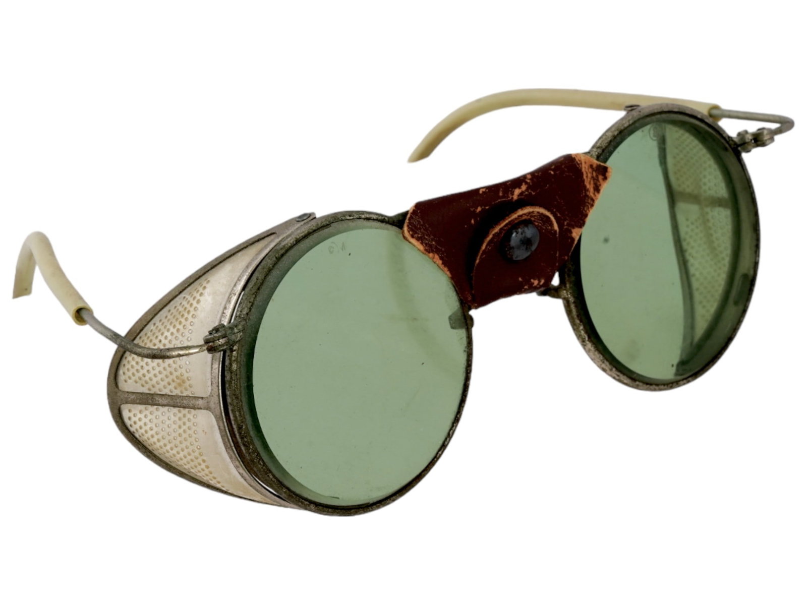 ANTIQUE AMERICAN AVIATOR GOGGLES W GREEN LENSES: An antique American aviator goggles with a leather nose and green lenses. Circa early 20th century. Aviation type sunglasses with flat green lenses. Brown leather nose bridge with clasp. Silver colore