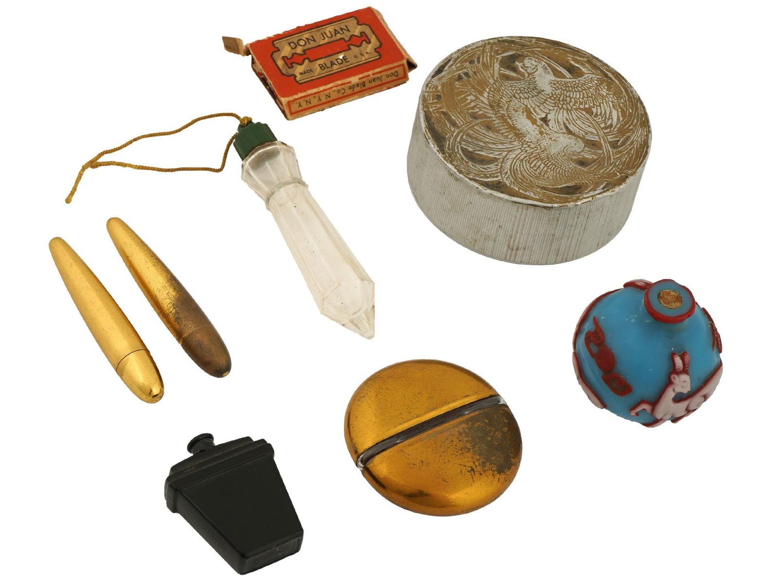 COLLECTION OF PERFUME BOTTLES AND SCENT FLASKS: A collection of assorted perfume bottles and scent flasks. The collection includes an oval shaped perfume bottle, marked Mary Dunhill; a pair of conical shaped perfume bottles; Don Juan razor blades;