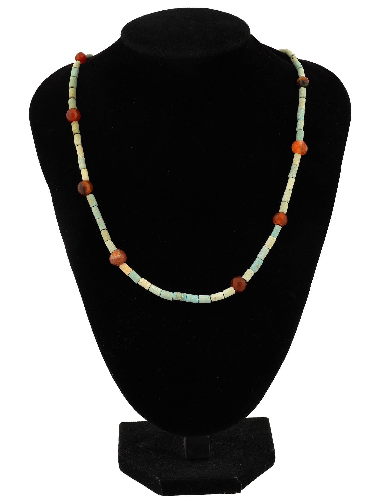 ANCIENT EGYPTIAN FAIENCE AND CARNELIAN NECKLACE: An ancient Egyptian necklace dating back to the Late Period, circa 700 to 200 BC. It features a combination of turquoise colored faience beads, carnelian beads. The faience beads are cylindrical and s