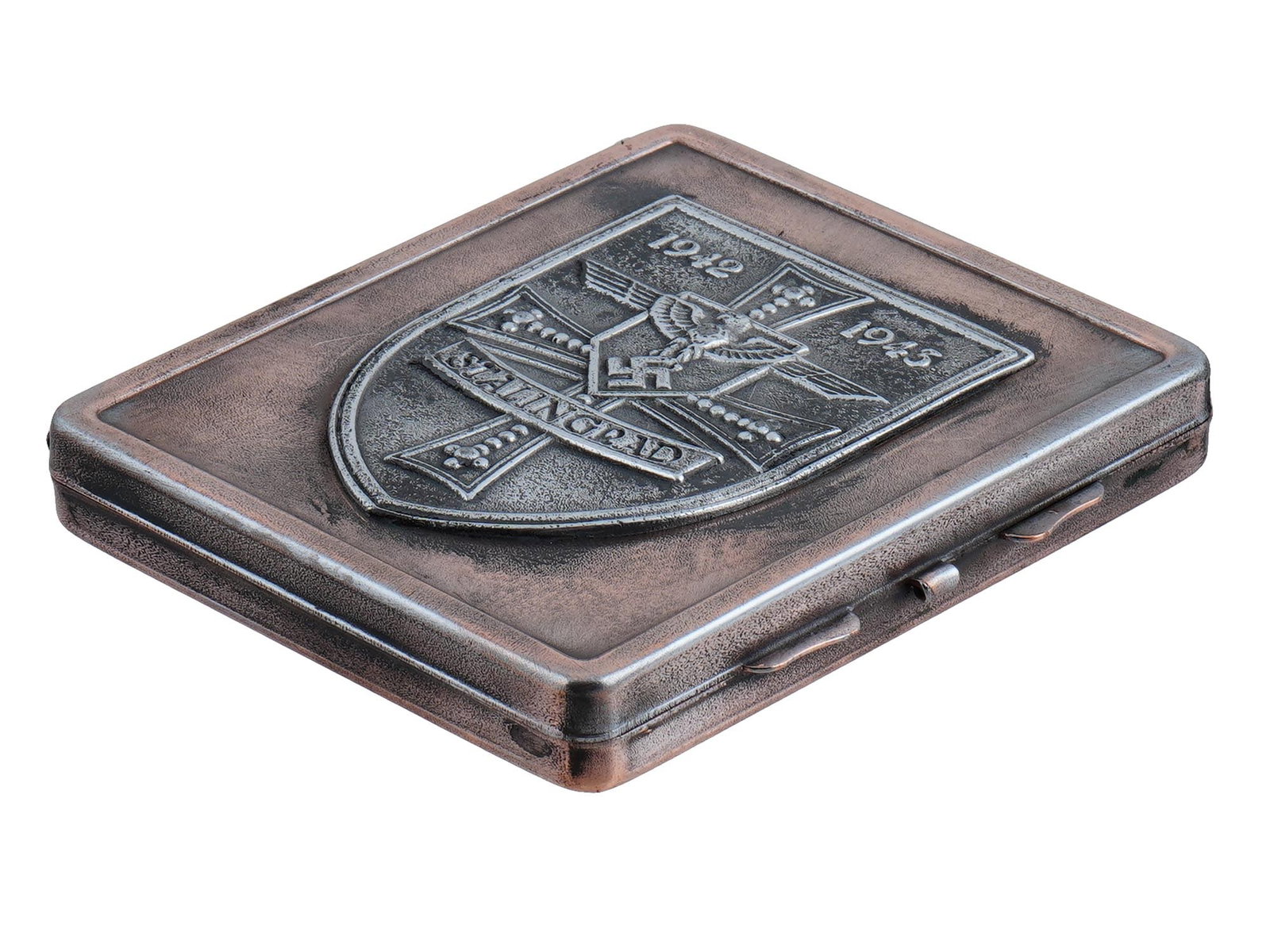 GERMAN WWII BATTLE FOR STALINGRAD CIGARETTE CASE: A World War II type German stainless steel cigarette case. The front cover is decorated with an embossed coat of arms which presents th German cross, Reichsadler with swastika, inscriptions 1942-1943,
