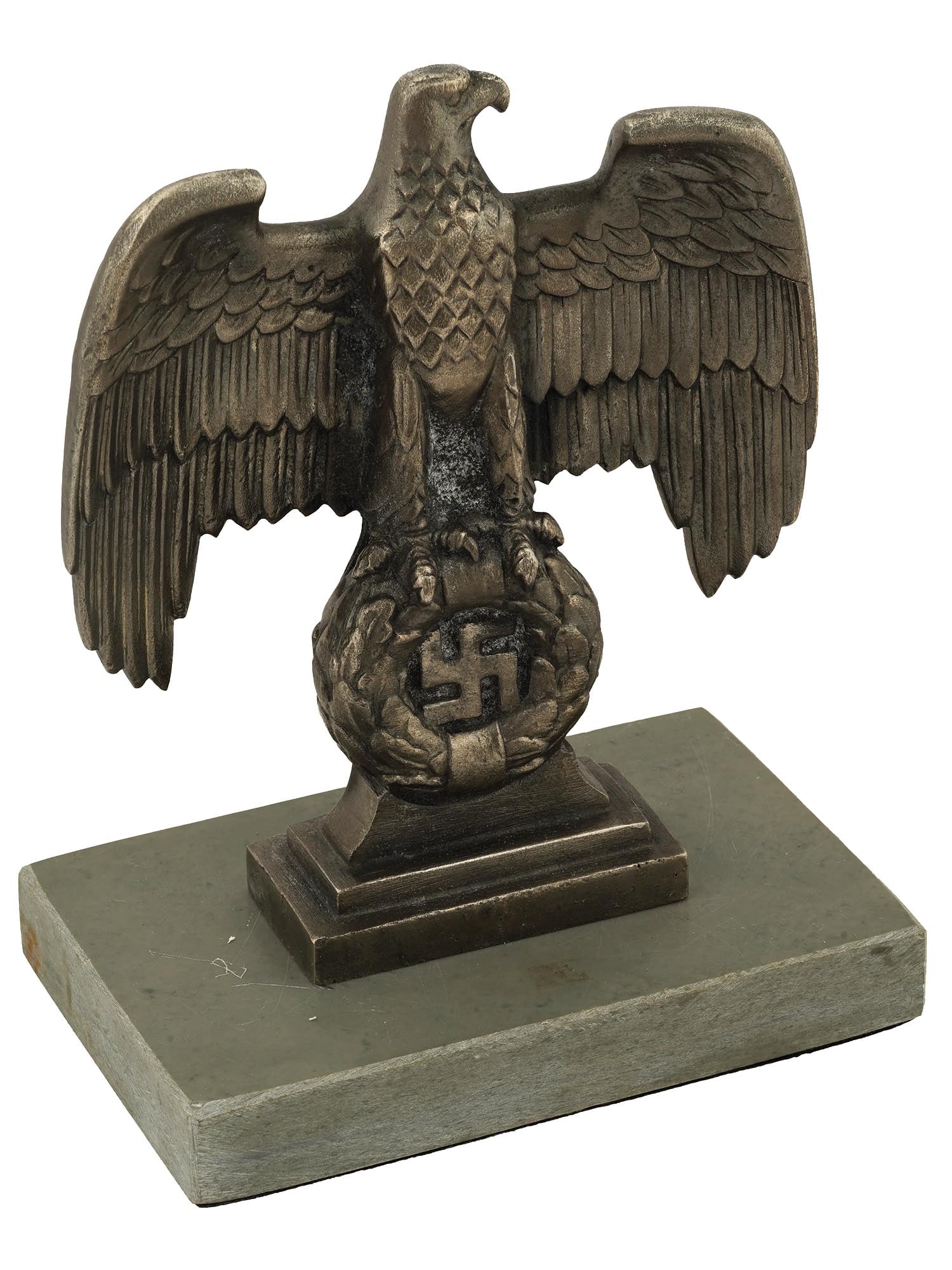 NAZI GERMAN WWII TYPE NUREMBERG DESK EAGLE FIGURINE: A Nazi German WWII type silver tone metal figurine, a miniature copy of the bronze Nuremberg eagles positioned to each side of the main podium at the Nuremberg rally grounds, the architectural symbol 